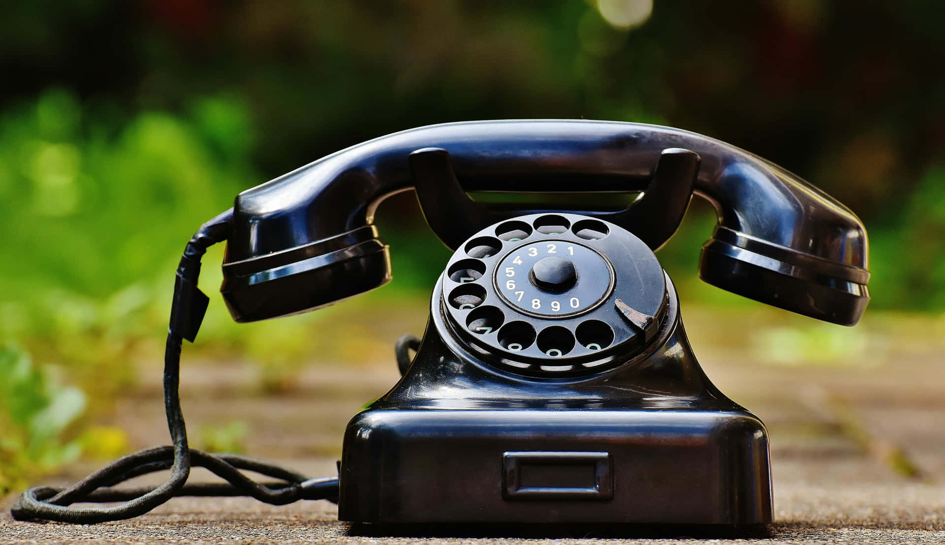 Vintage Black Rotary Telephone Outdoors Wallpaper