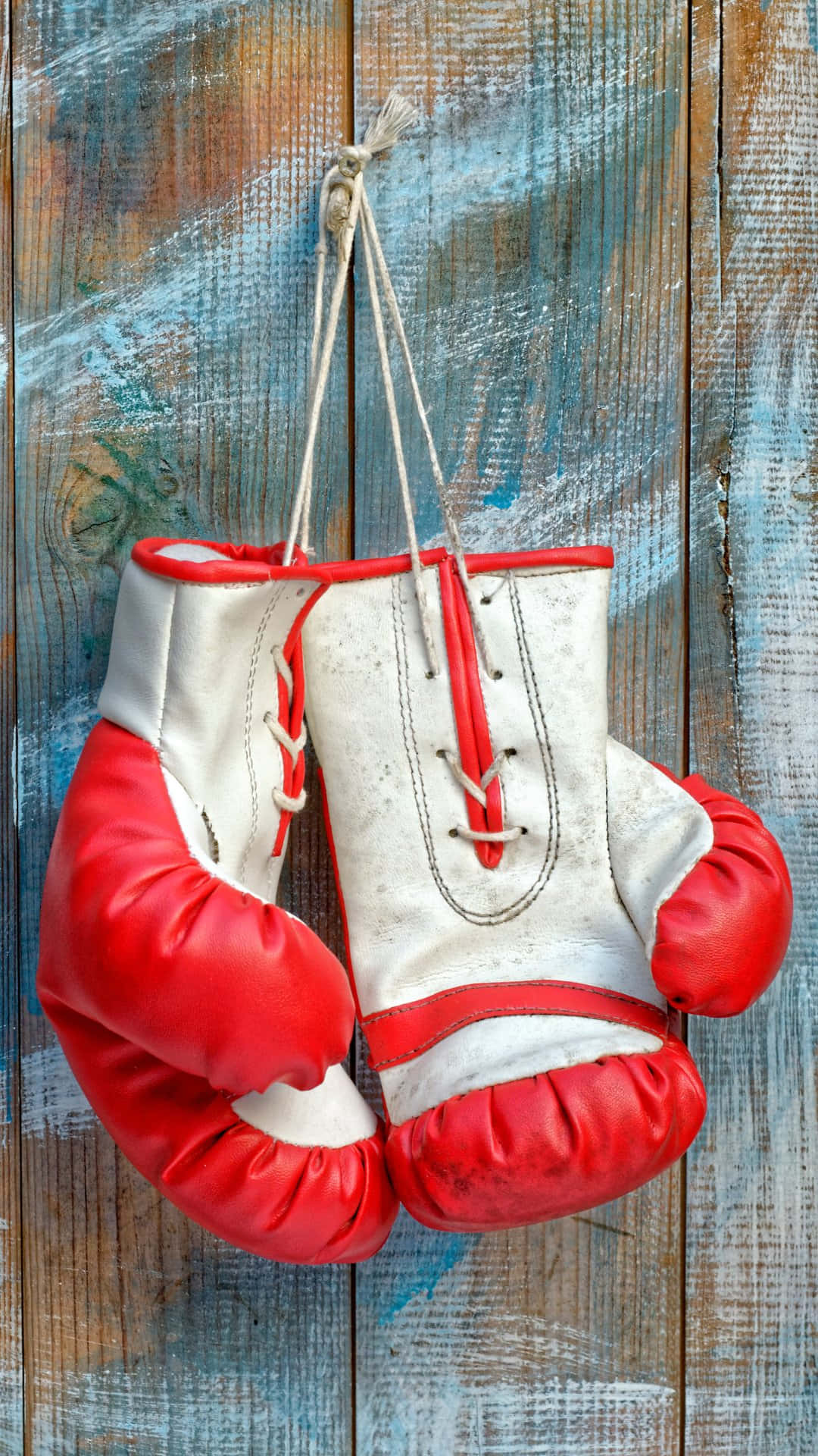 Vintage Boxing Gloves Hangingon Wooden Background Wallpaper
