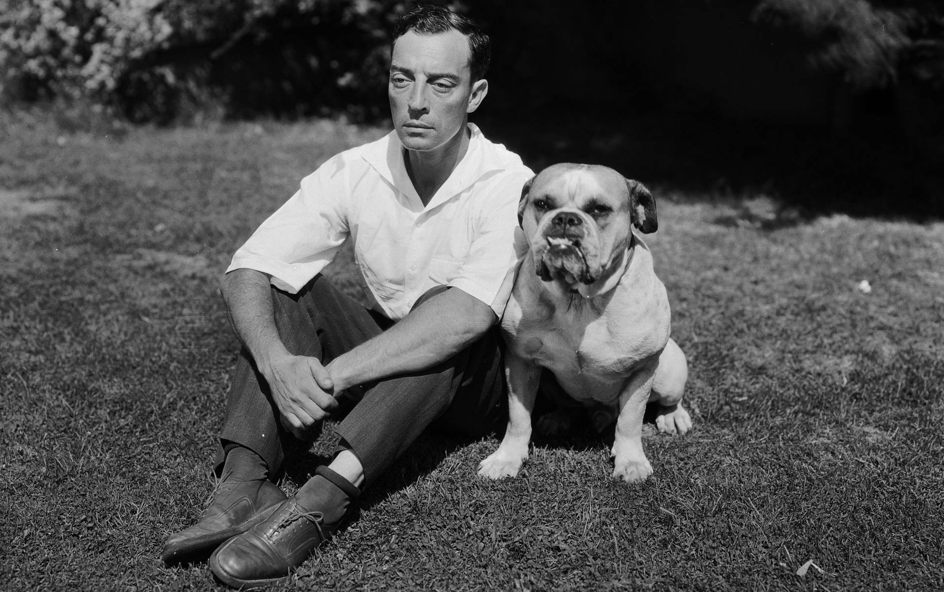 Buster Keaton with his loyal sidekick dog in a vintage setting. Wallpaper