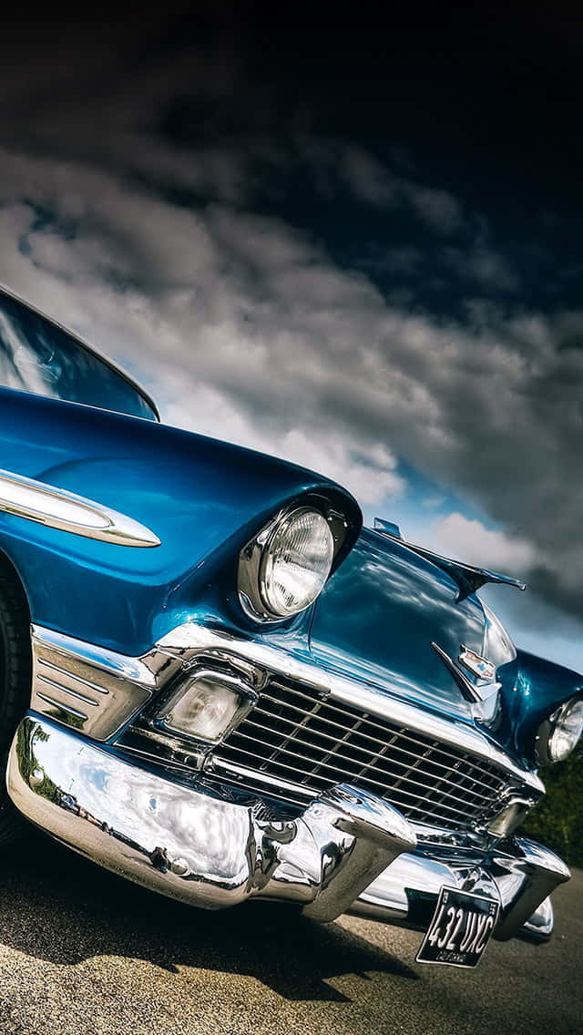 A Blue Classic Car Parked On A Street Wallpaper
