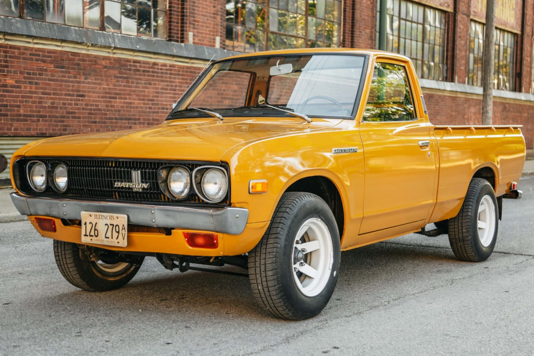 Vintage Datsun 620 On A Lush Landscape Wallpaper