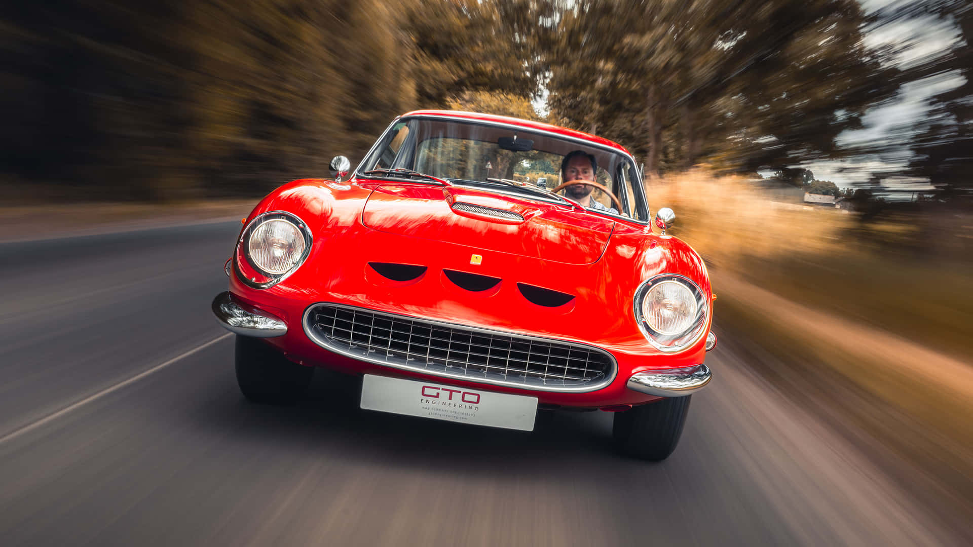 Oplev kunsten at køre en vintage Ferrari Wallpaper