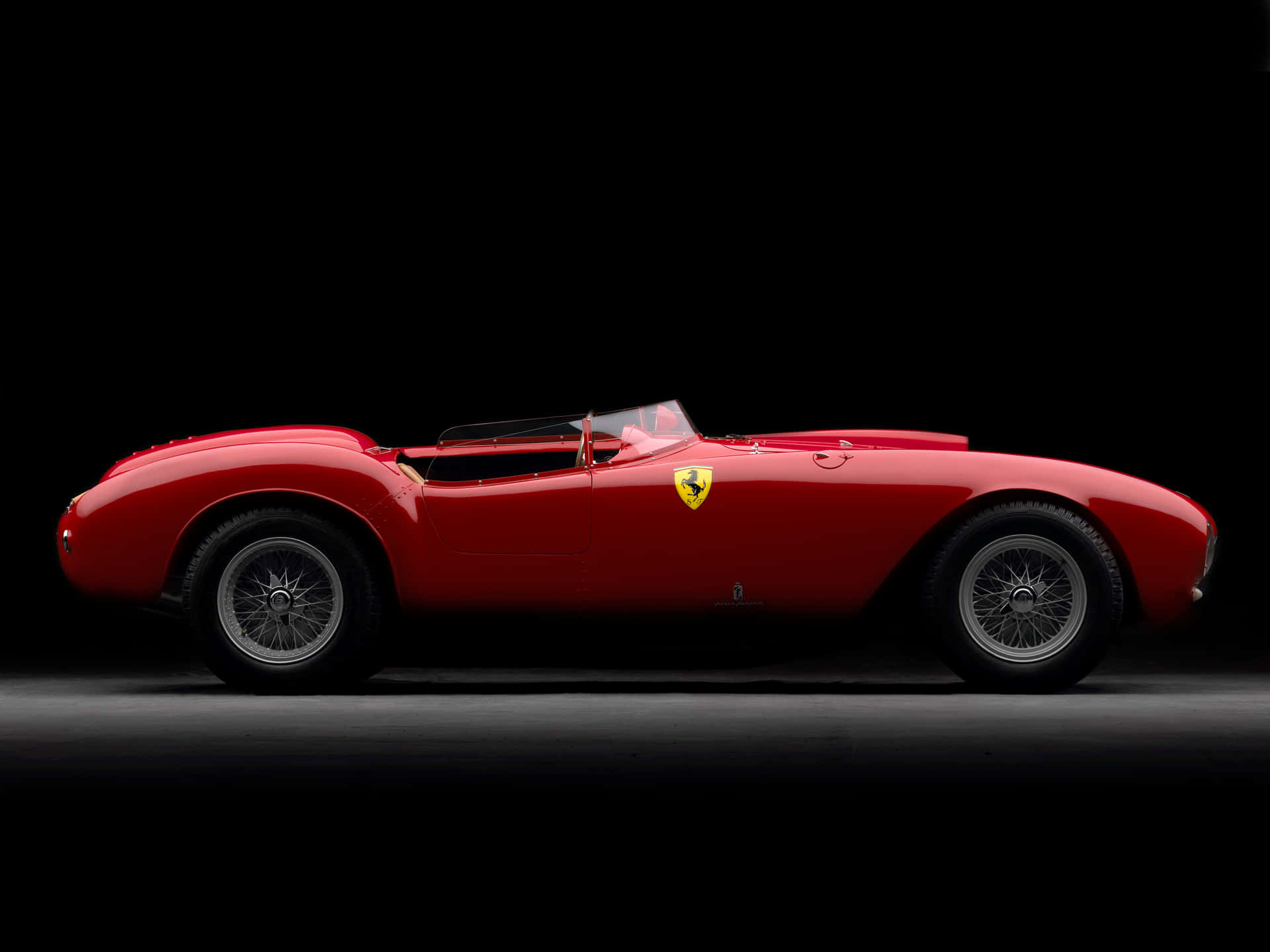 Klassisk Ferrari Race Gennem et Europæisk Landskab Wallpaper