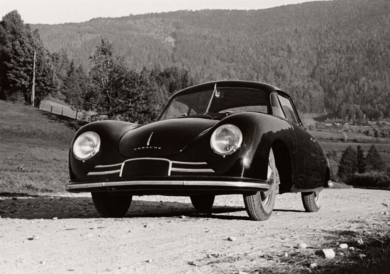 Vintage Porsche 356 Against A Scenic Backdrop Wallpaper