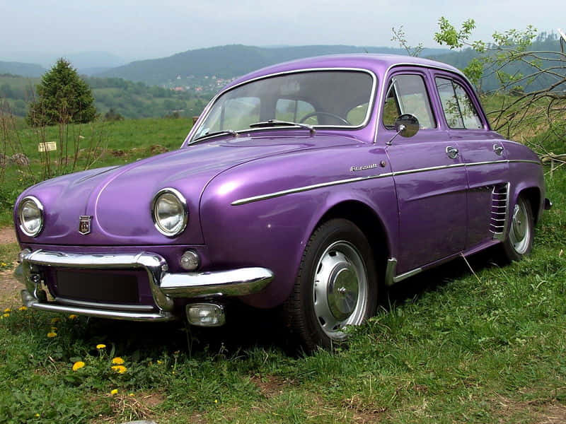 Vintage Renault Dauphine Parked On Cobblestone Road Wallpaper