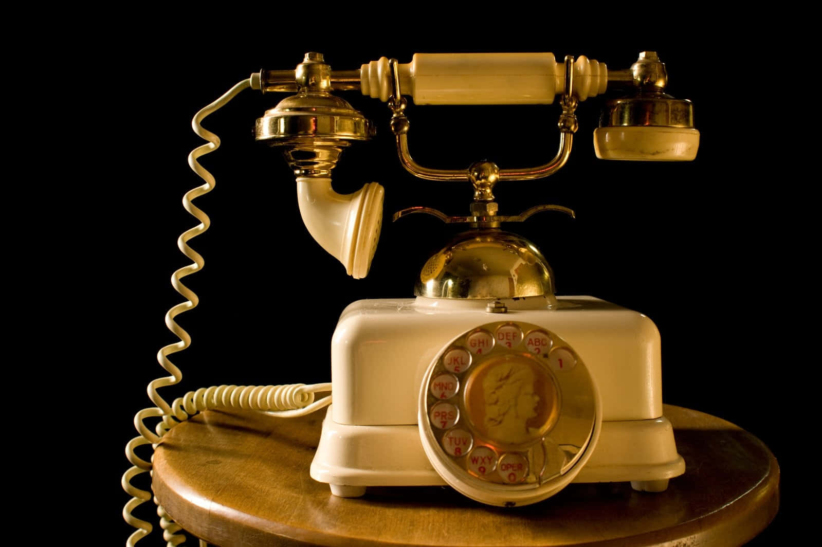Vintage Rotary Telephoneon Wooden Table Wallpaper