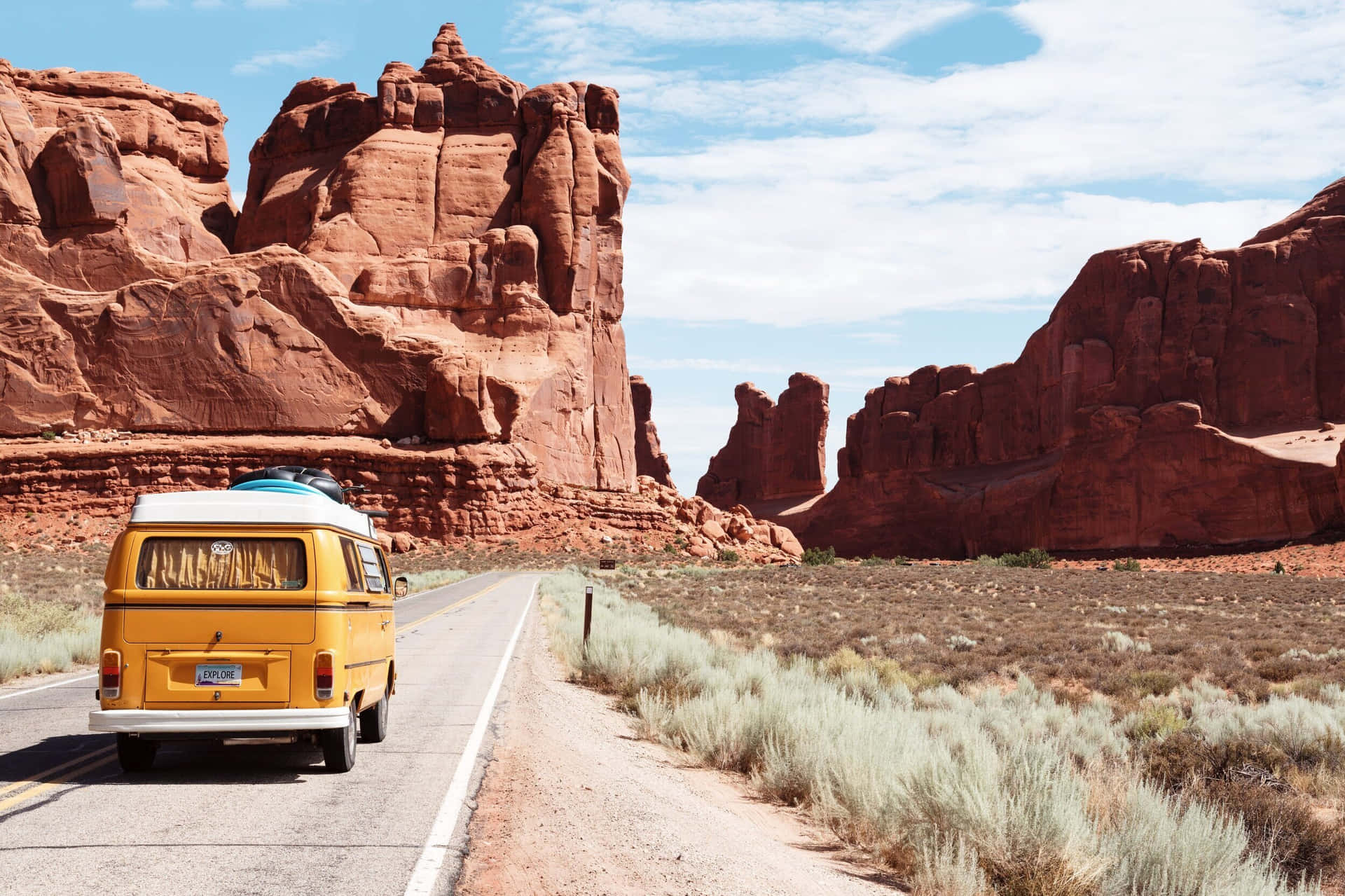 Vintage Yellow Van Desert Road Trip Wallpaper
