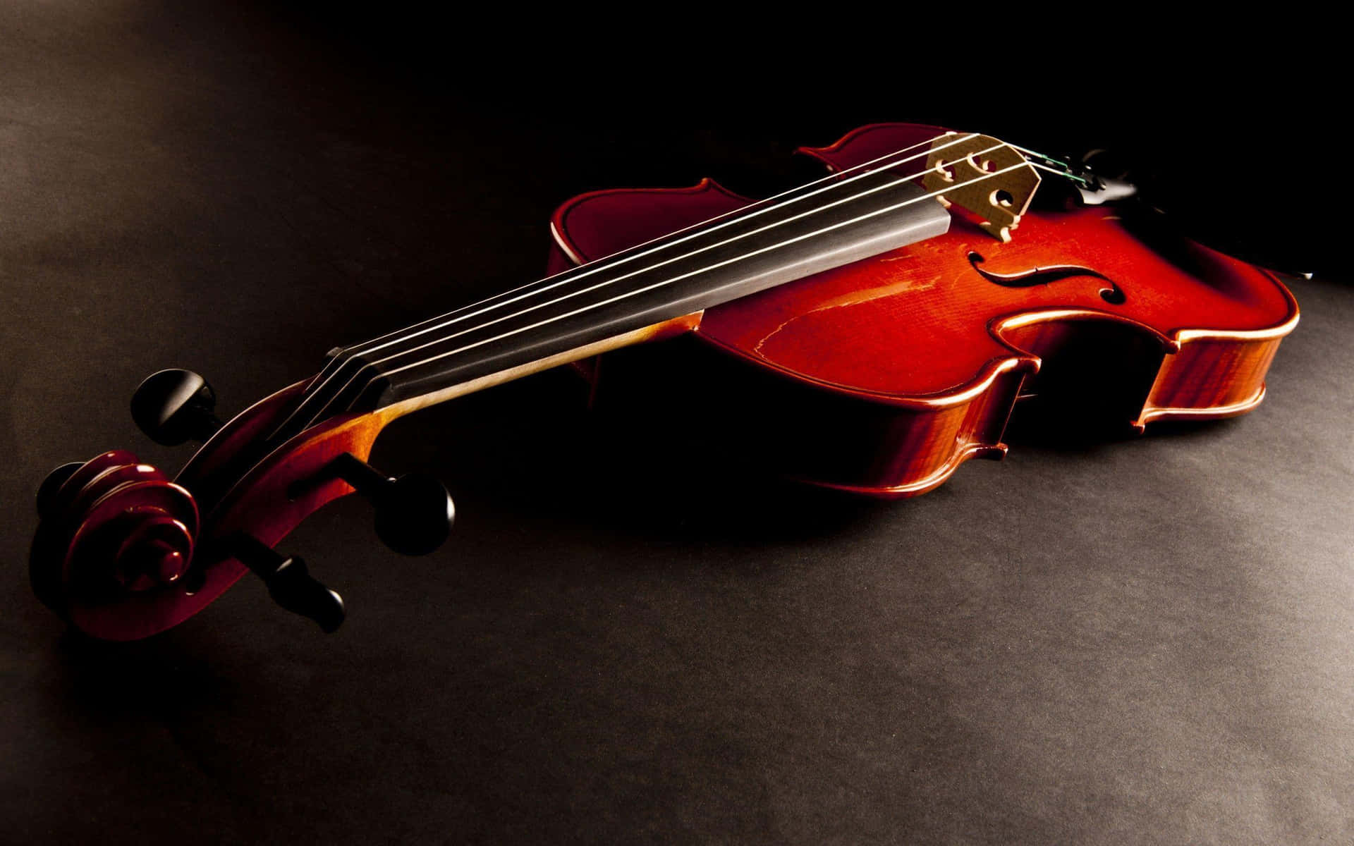 An artist performing at their utmost potential with a painted violin masterpiece. Wallpaper