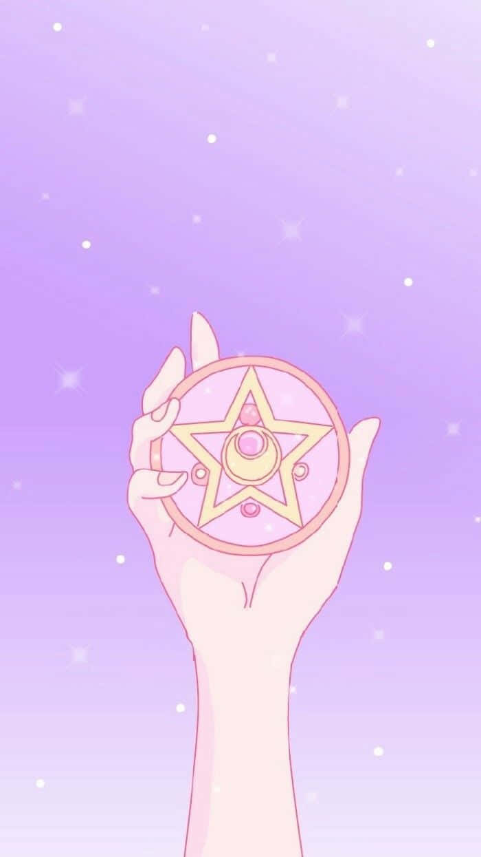 A Hand Holding A Star Shaped Disc Wallpaper