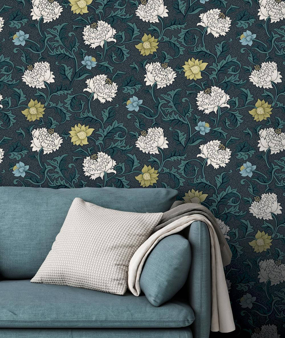 A Blue Couch With Floral Wallpaper In Front Of It Wallpaper