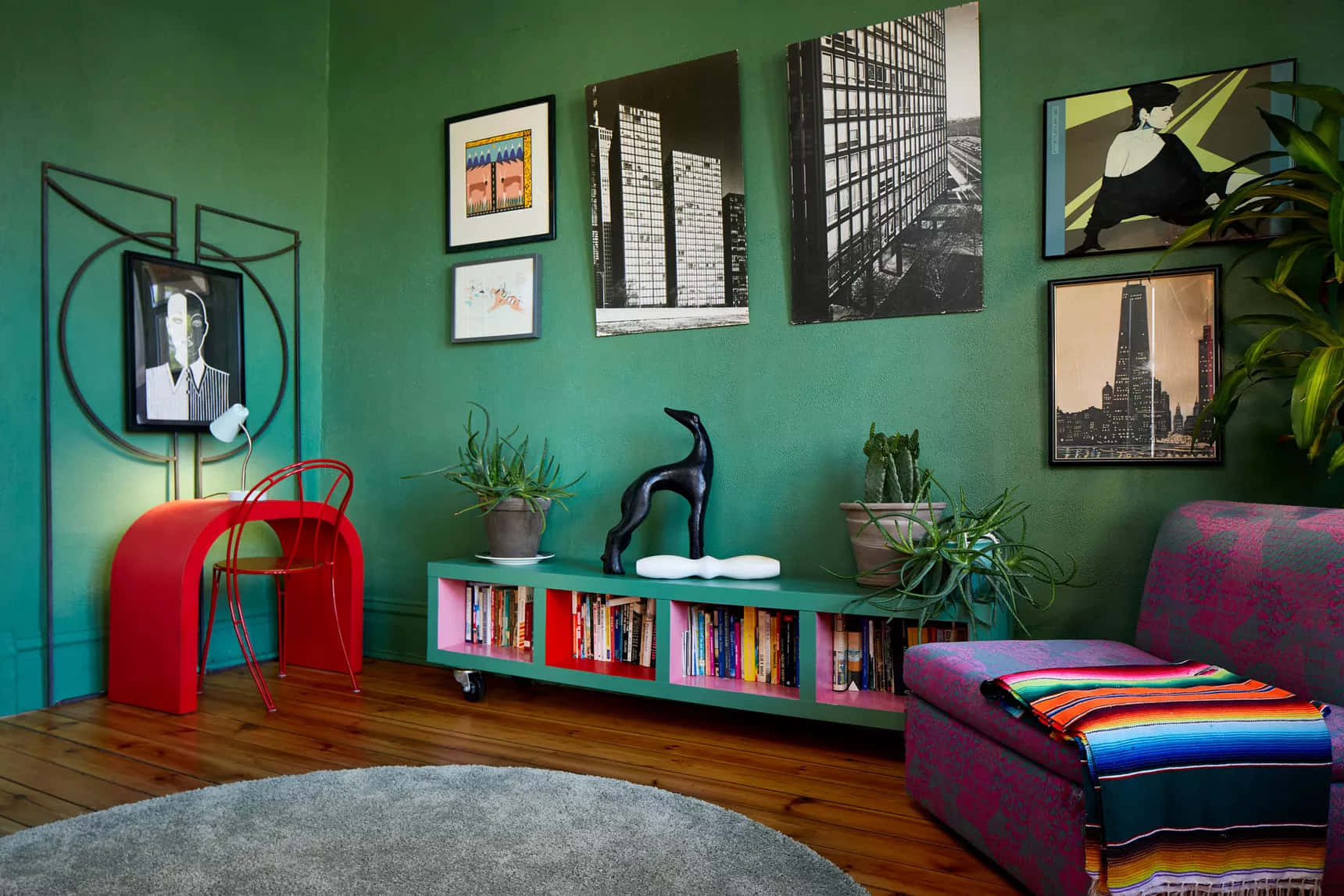 A Living Room With Green Walls And A Red Chair