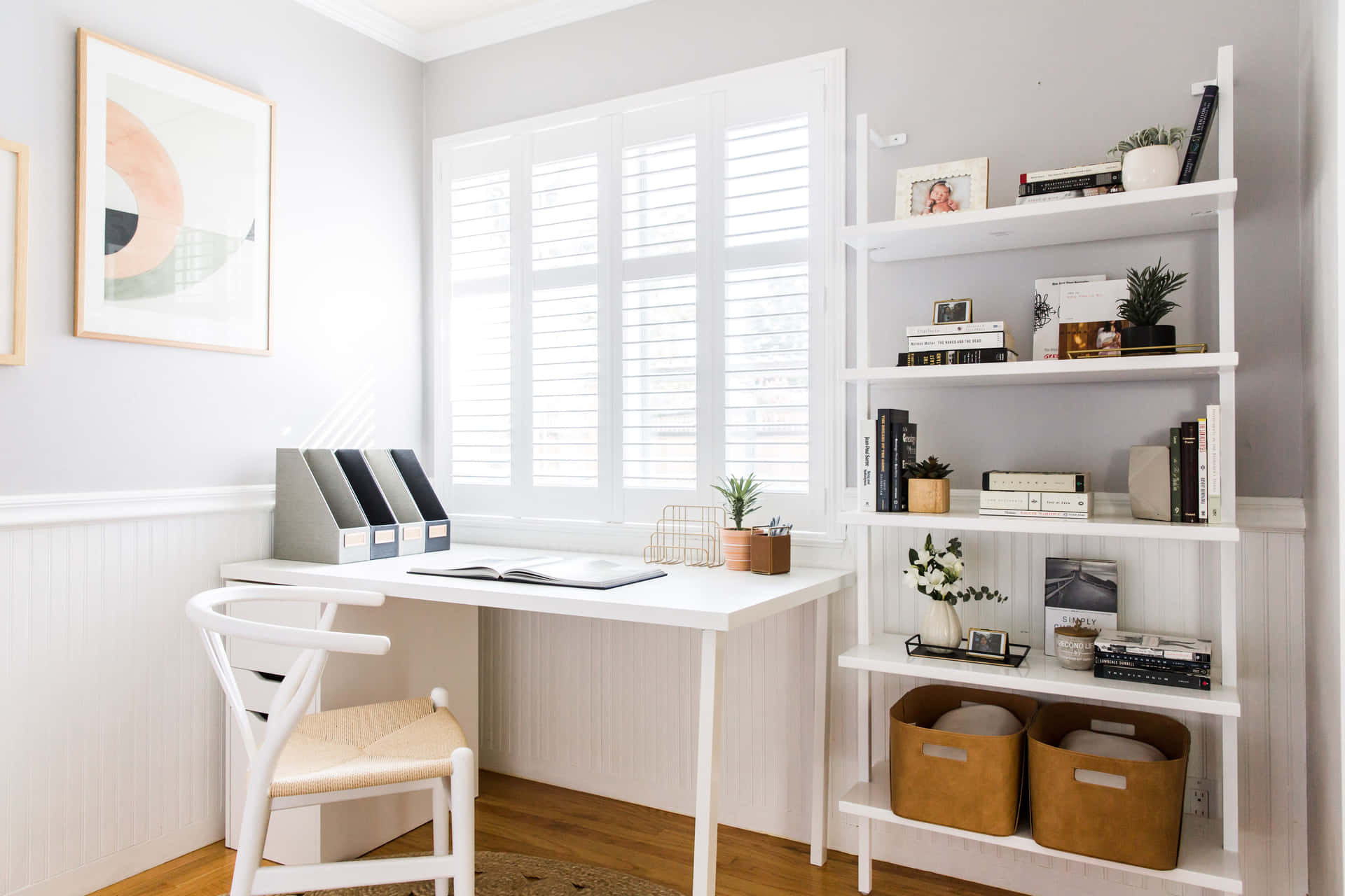 A White Home Office With A Chair And Bookshelves