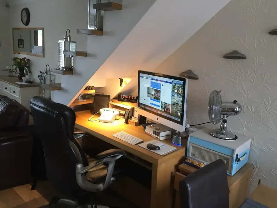 A Living Room With A Computer Desk And Chair