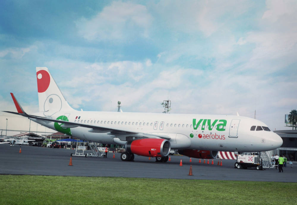 Viva Aerobus On Grass Runway Under Sky Wallpaper