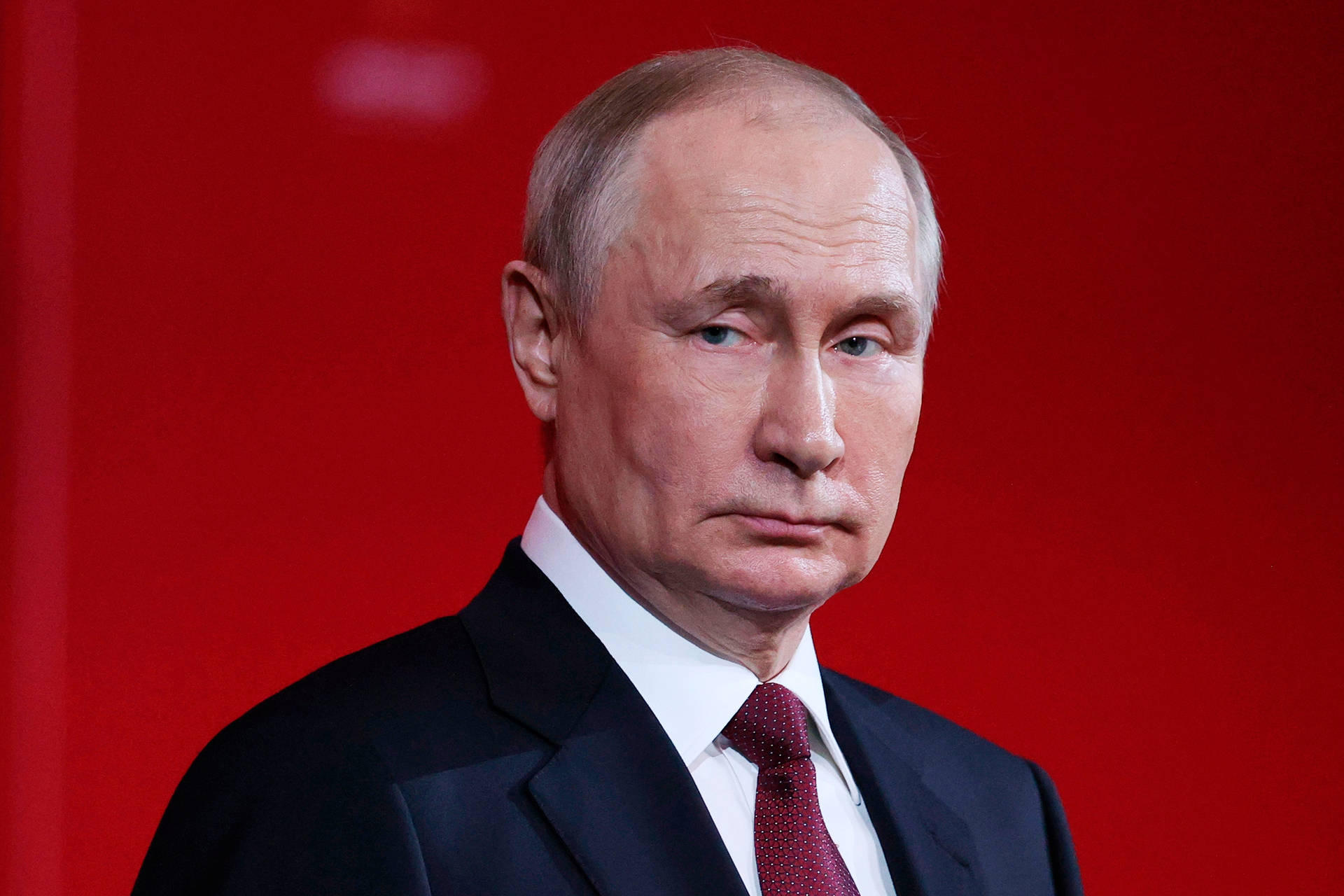 Vladimir Putin Against Blurry Red Backdrop Wallpaper