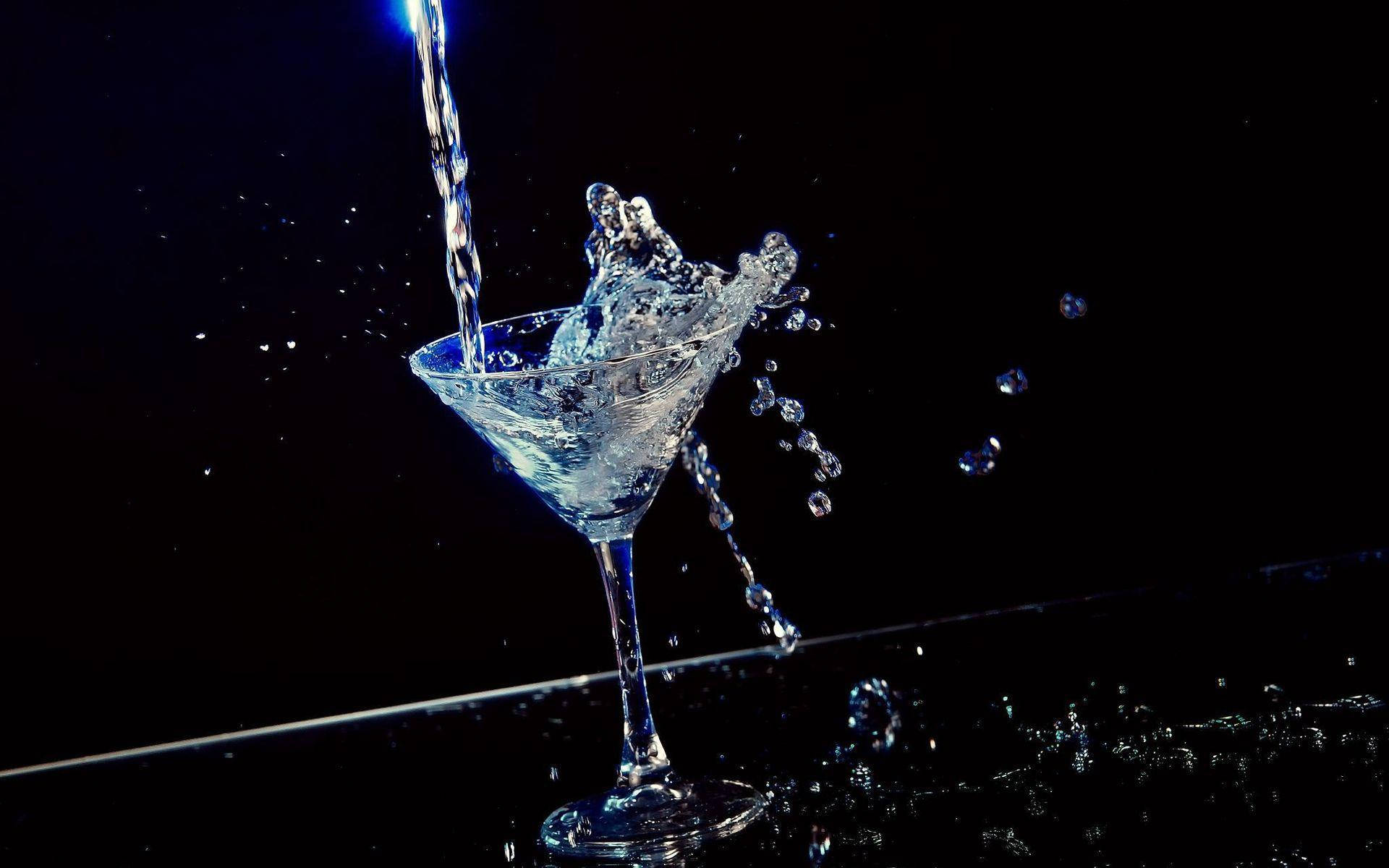 Vodka Splashing On A Cocktail Glass Wallpaper