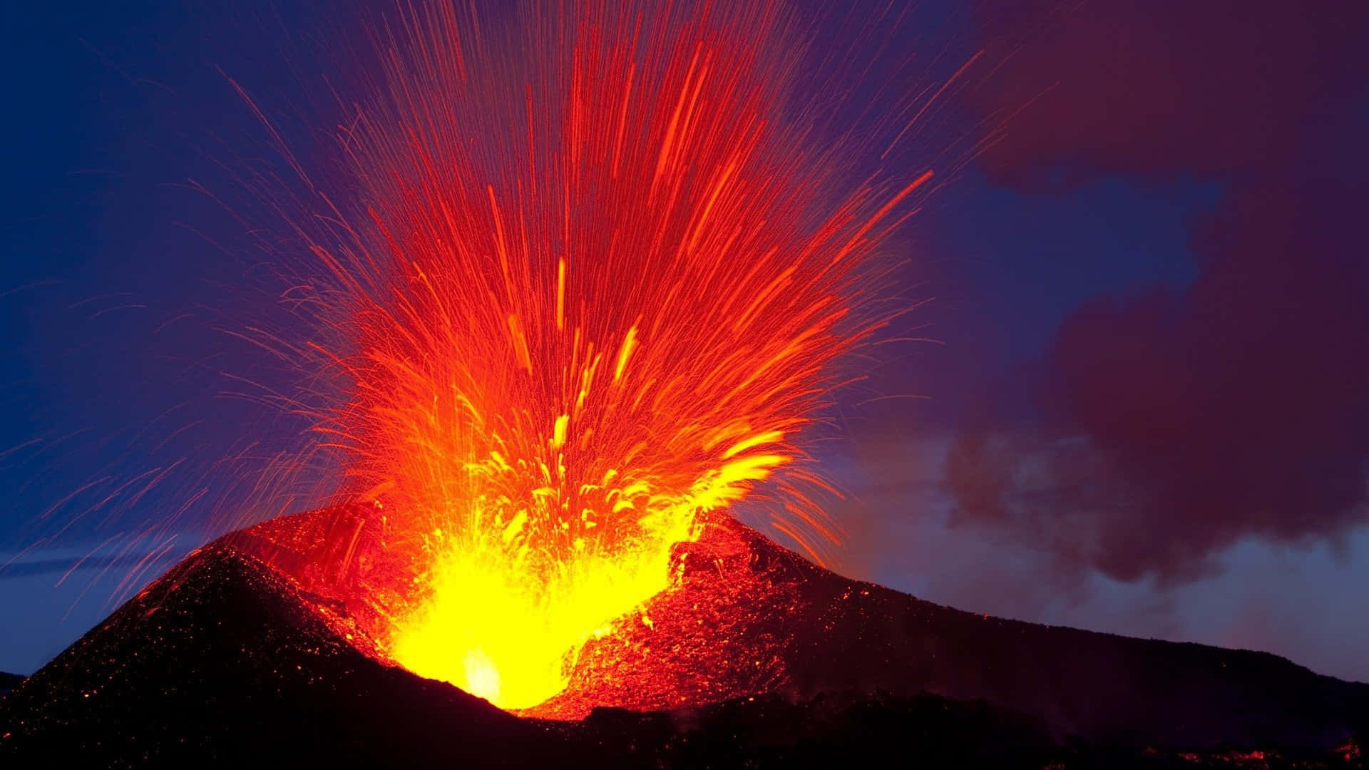 An active volcano spewing smoke and lava in a stunning location