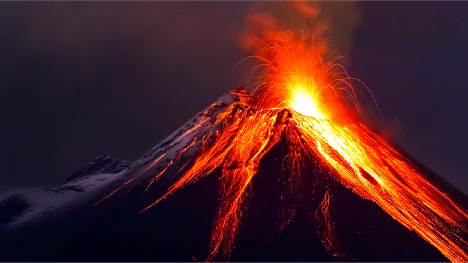Steam rises from molten lava erupting from the active volcano