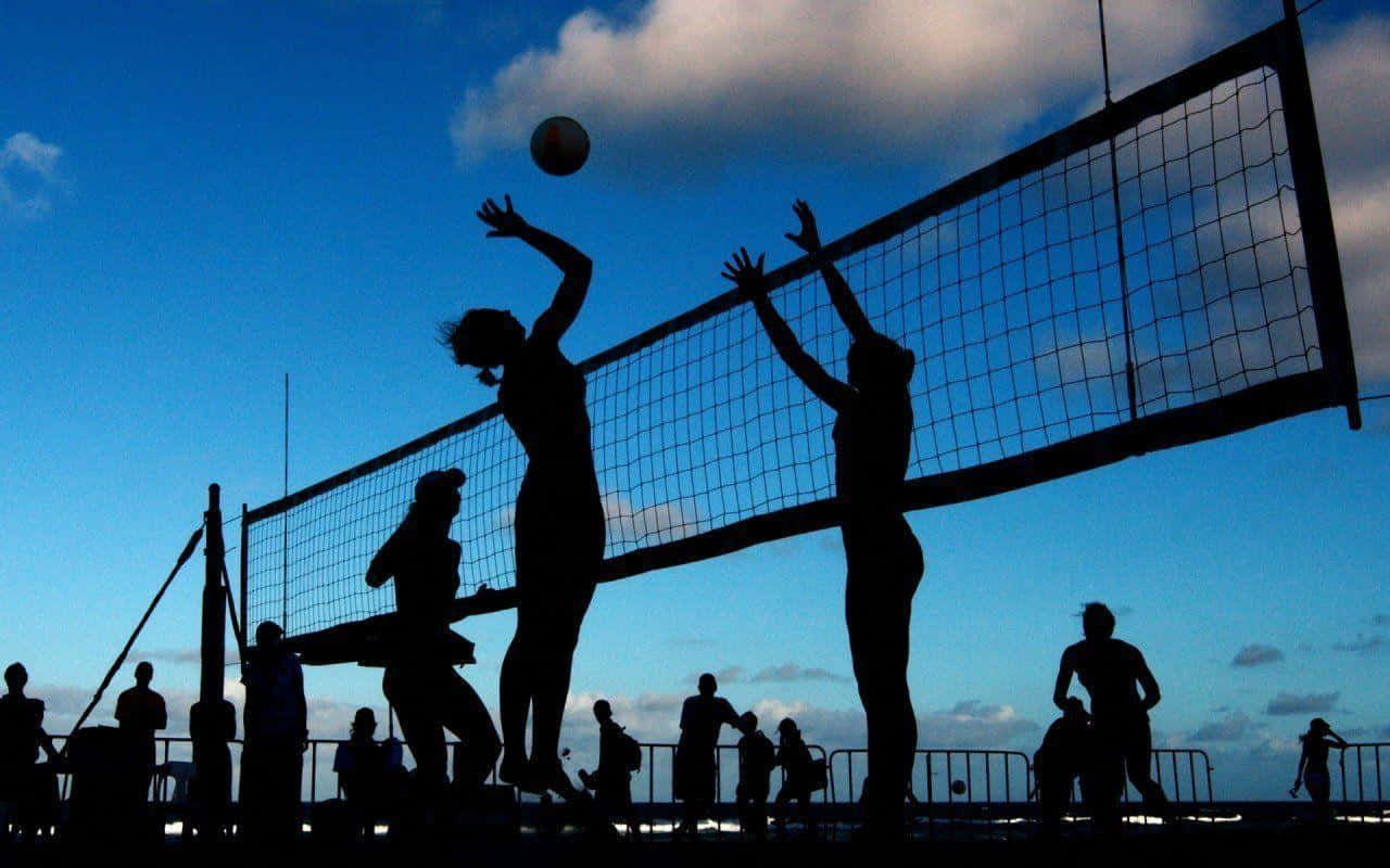 Silhouettes Of People Playing Volleyball