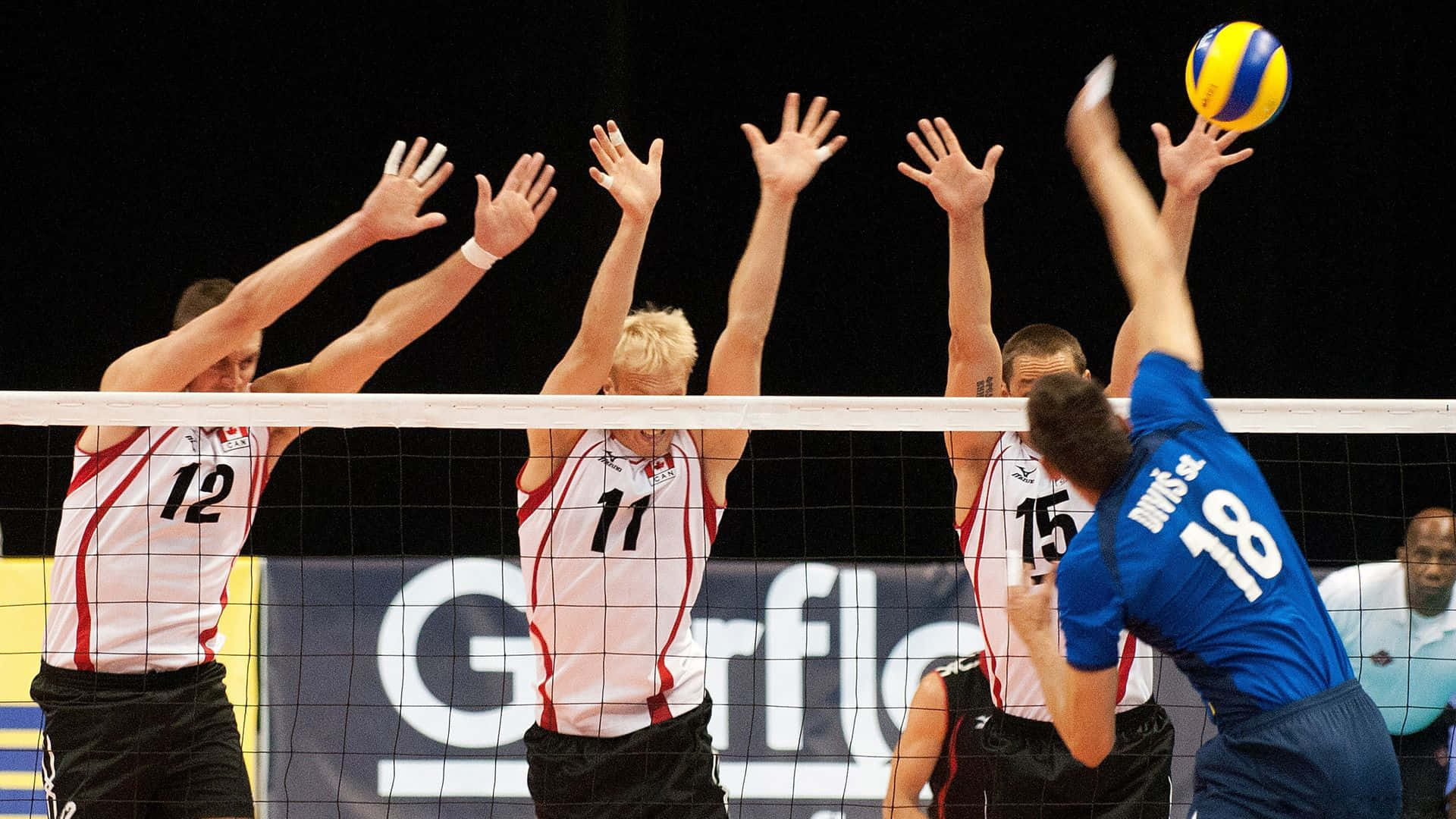 A Group Of Men Playing Volleyball
