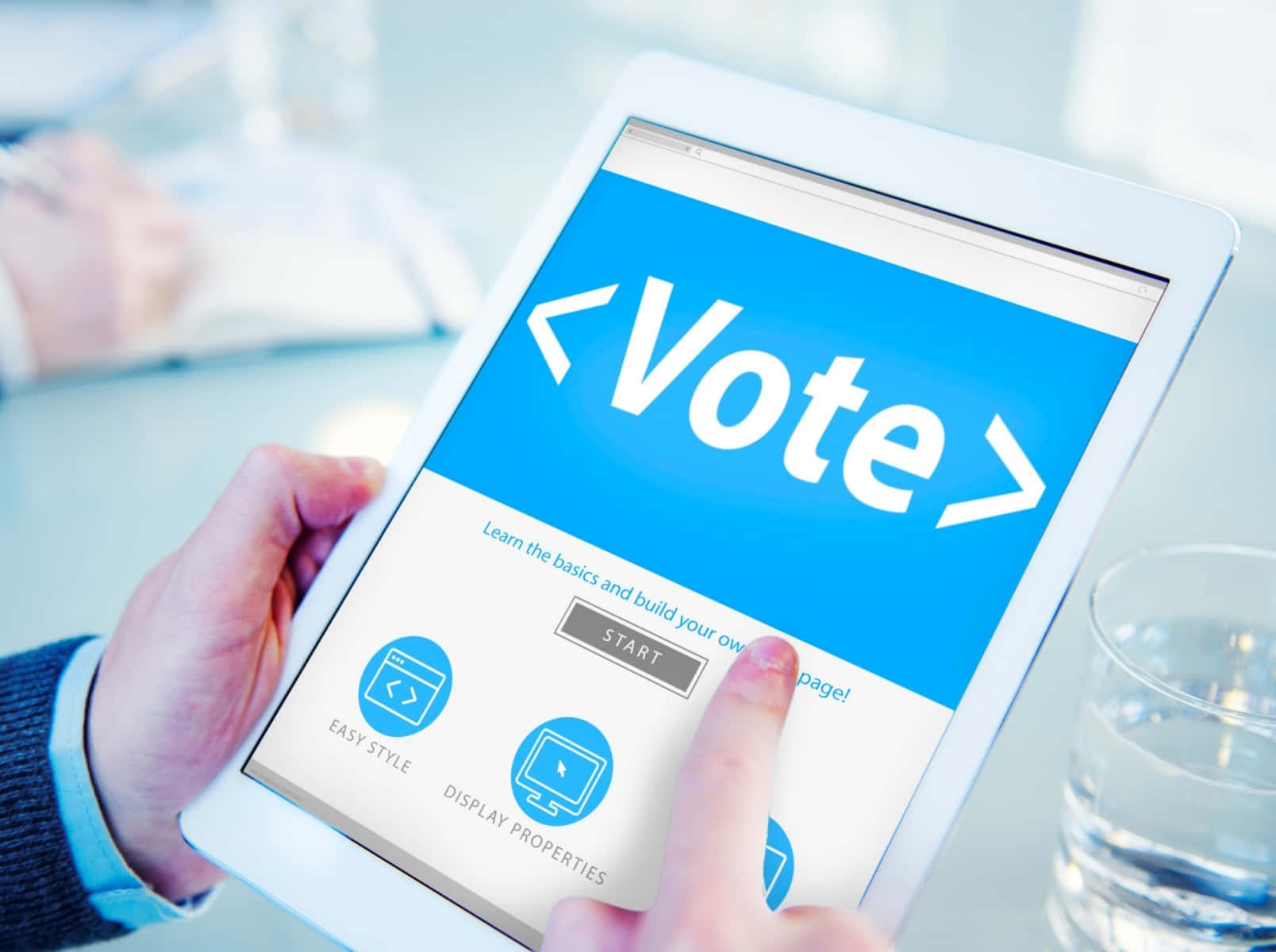 A Person Is Holding A Tablet With The Word Vote On It