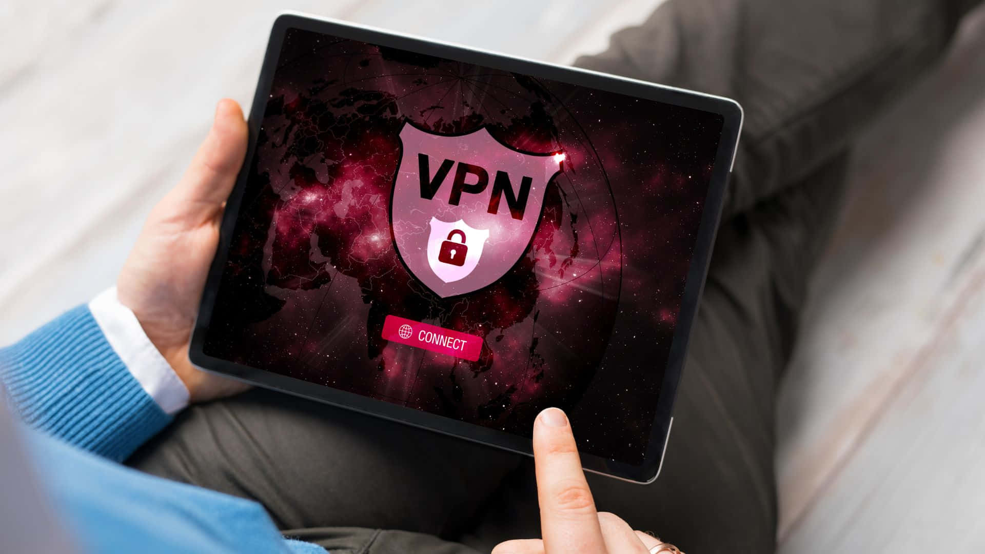 A Man Holding A Tablet With A Vpn On It Wallpaper