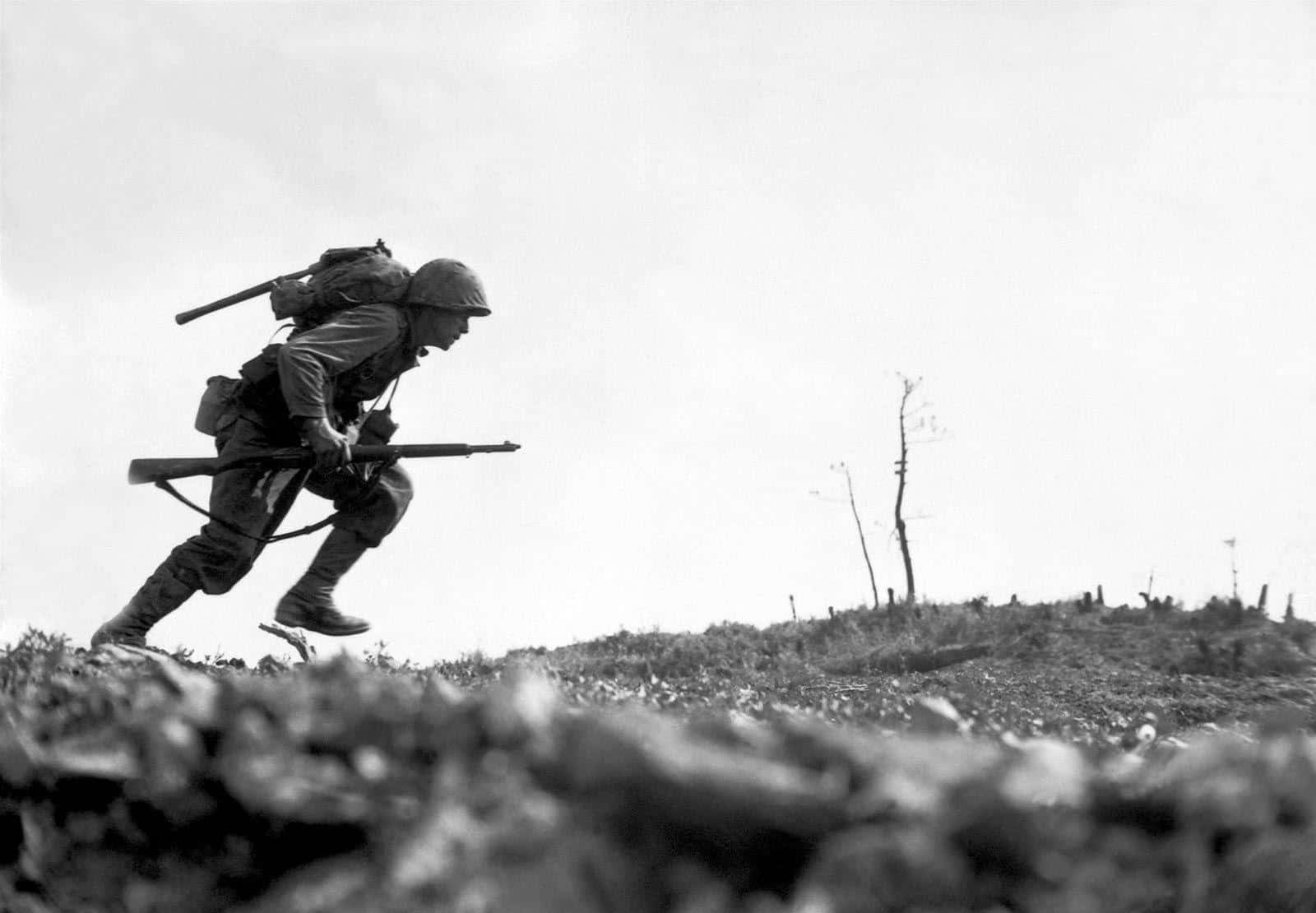 W W I I Soldier Advancing Over Hill Wallpaper
