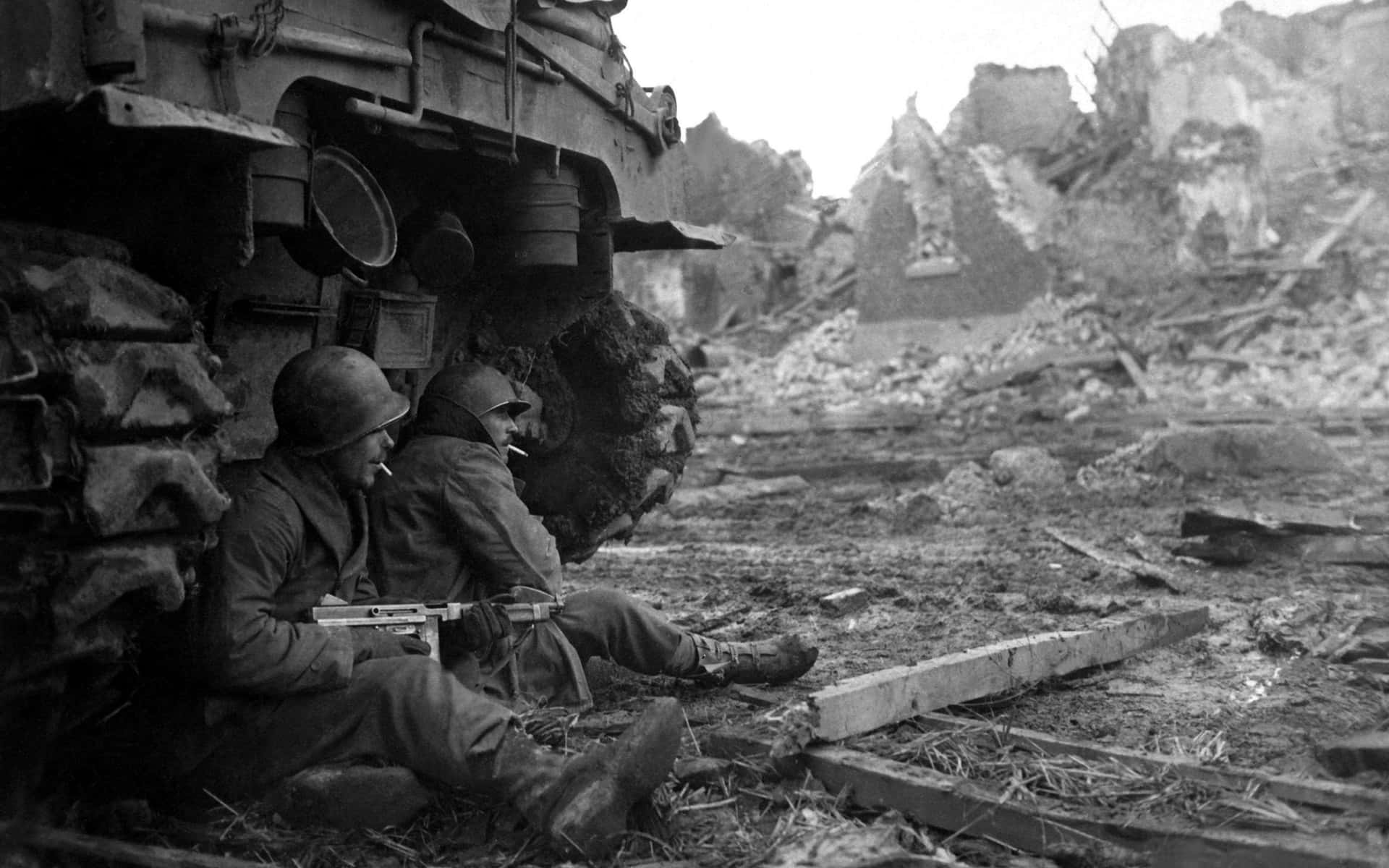 W W2 Soldiers Taking Cover Beside Tank Wallpaper