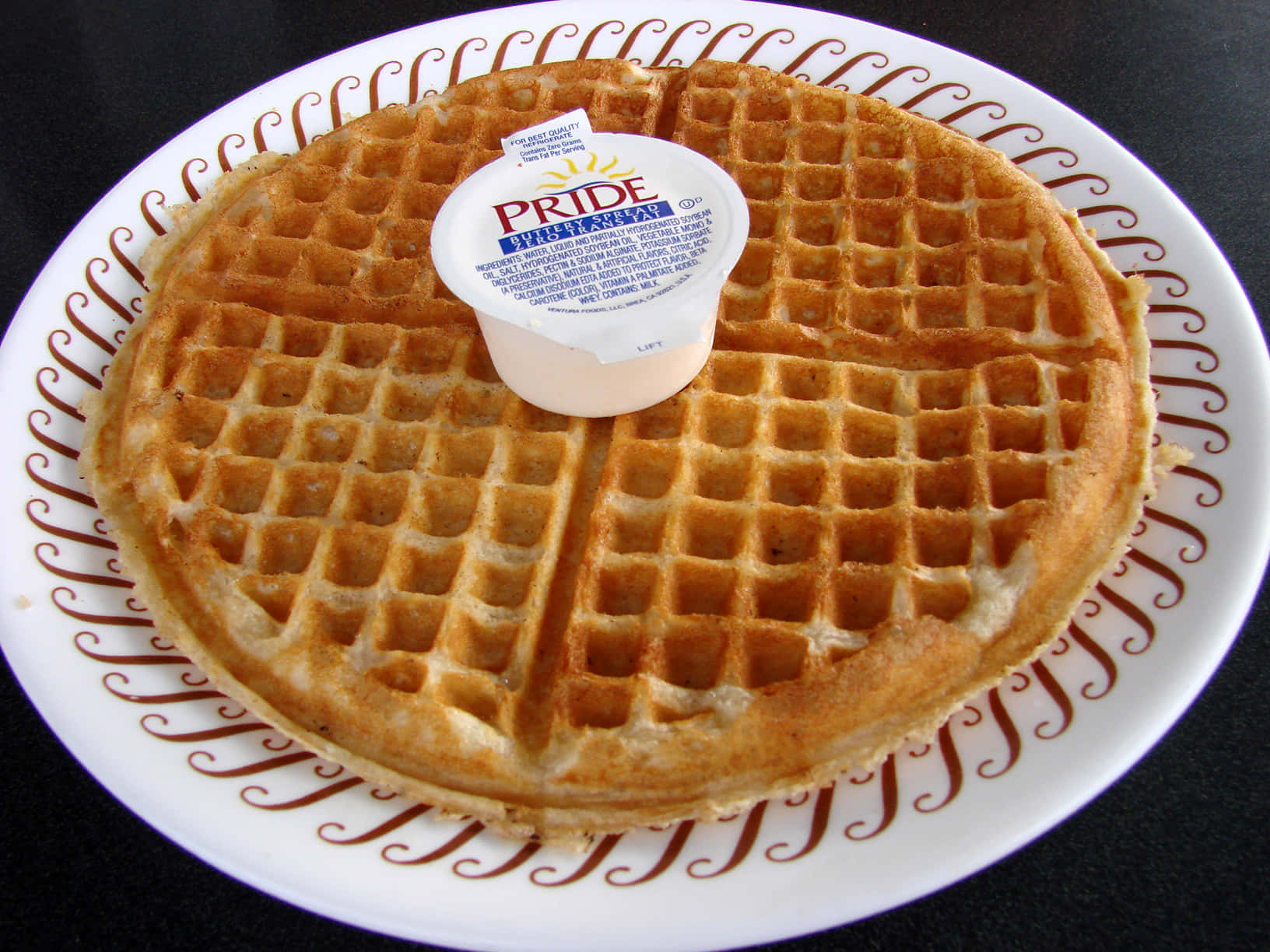Delicious, golden-brown waffle with butter and syrup