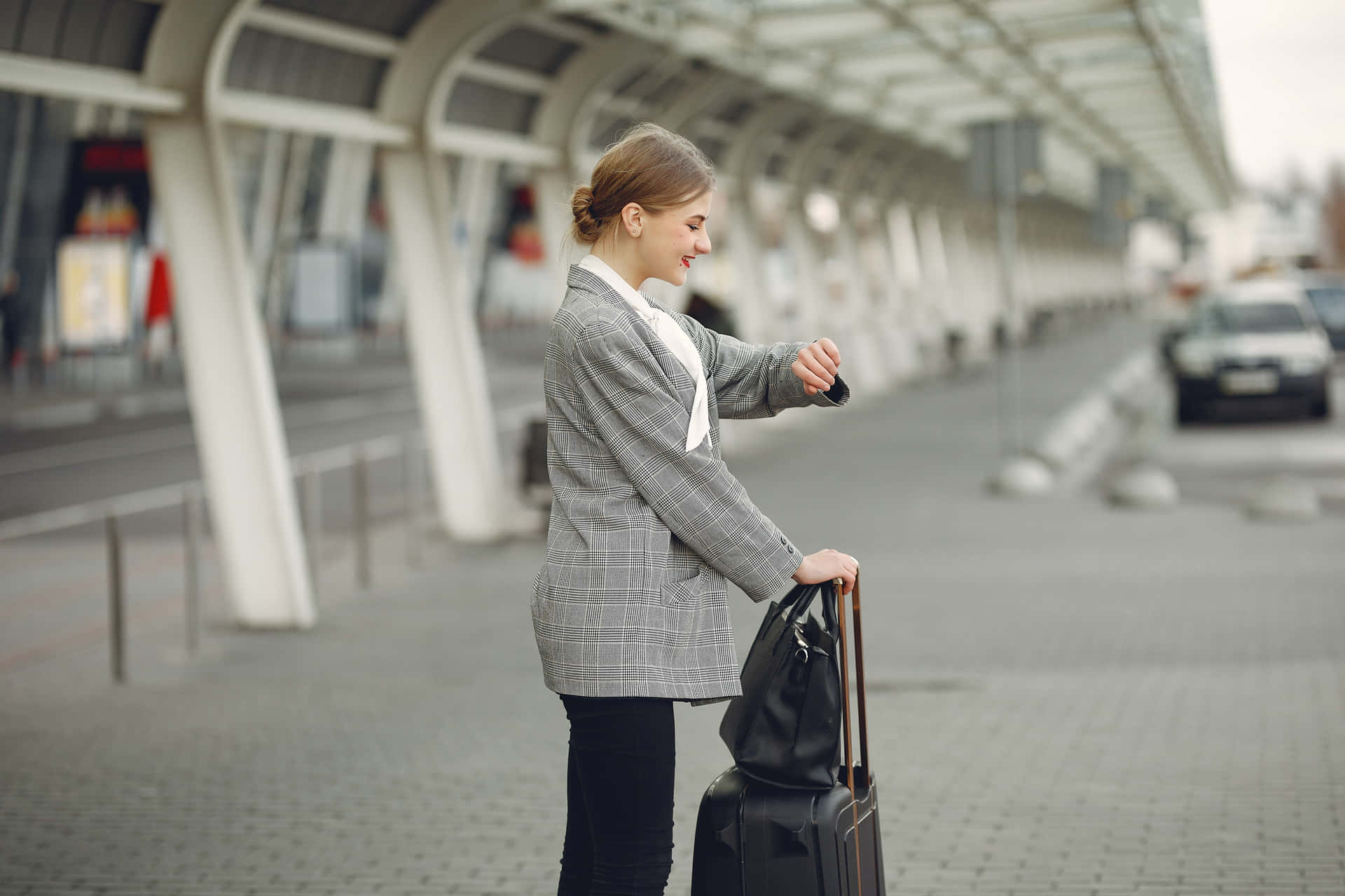 A Woman Is Standing With Her Suitcase