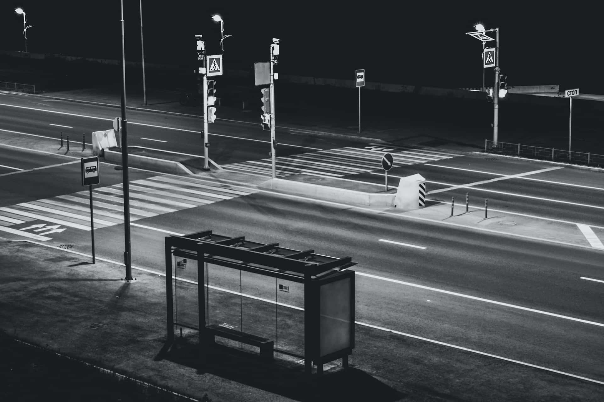 A Black And White Photo Of A Bus Stop