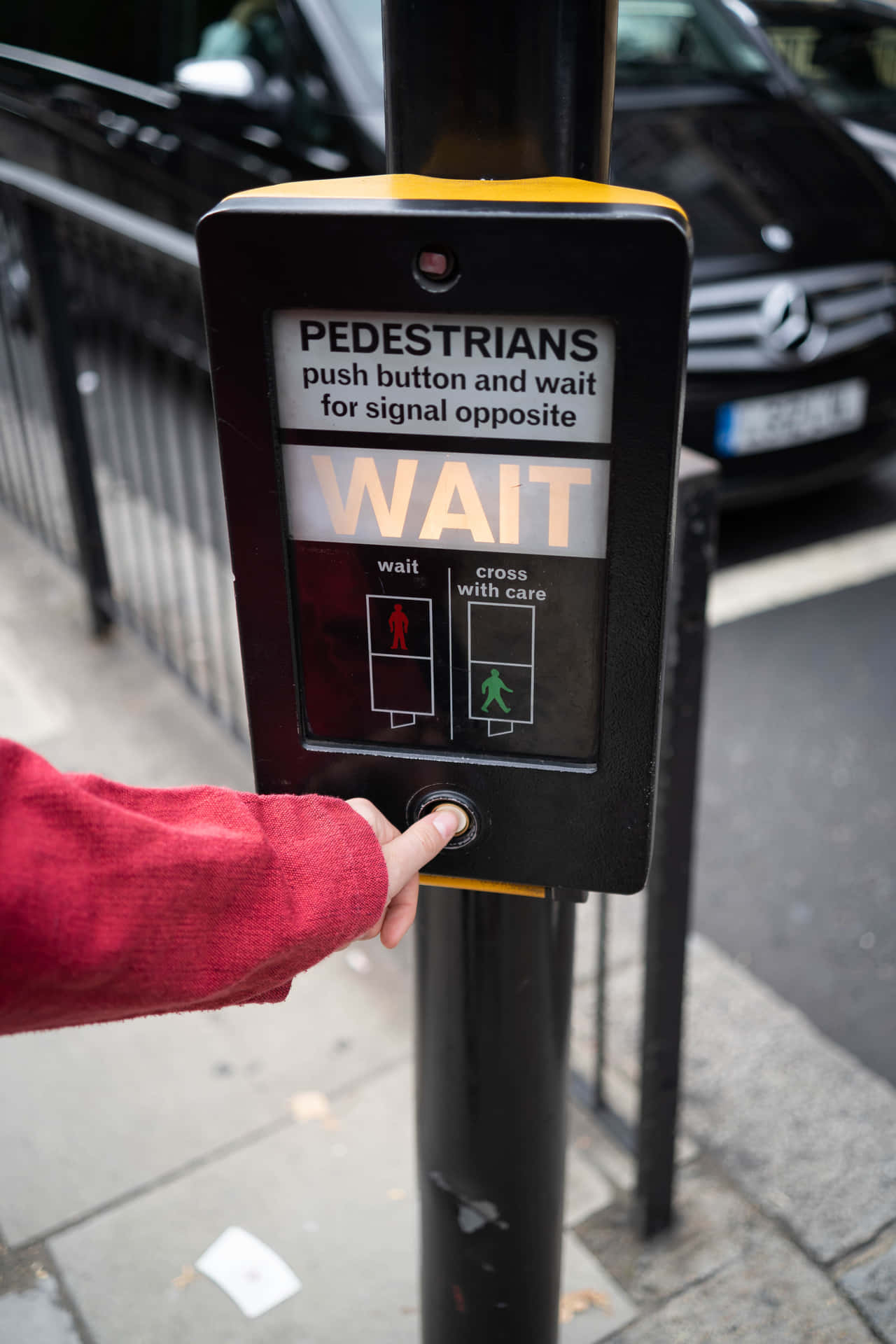 A Person Is Putting Their Hand On A Street Sign