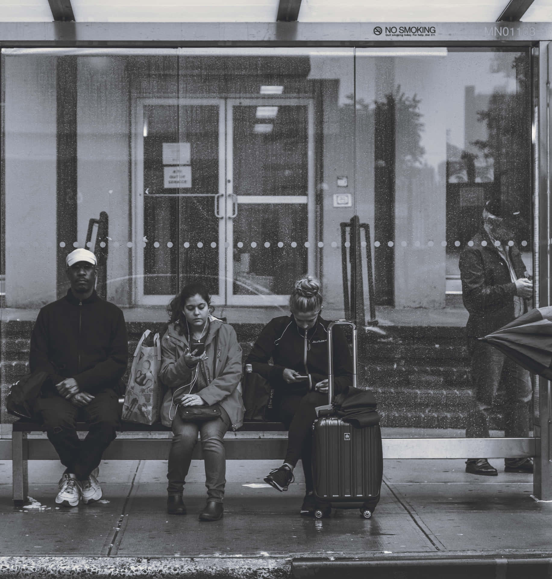 A Group Of People Sitting On A Bench