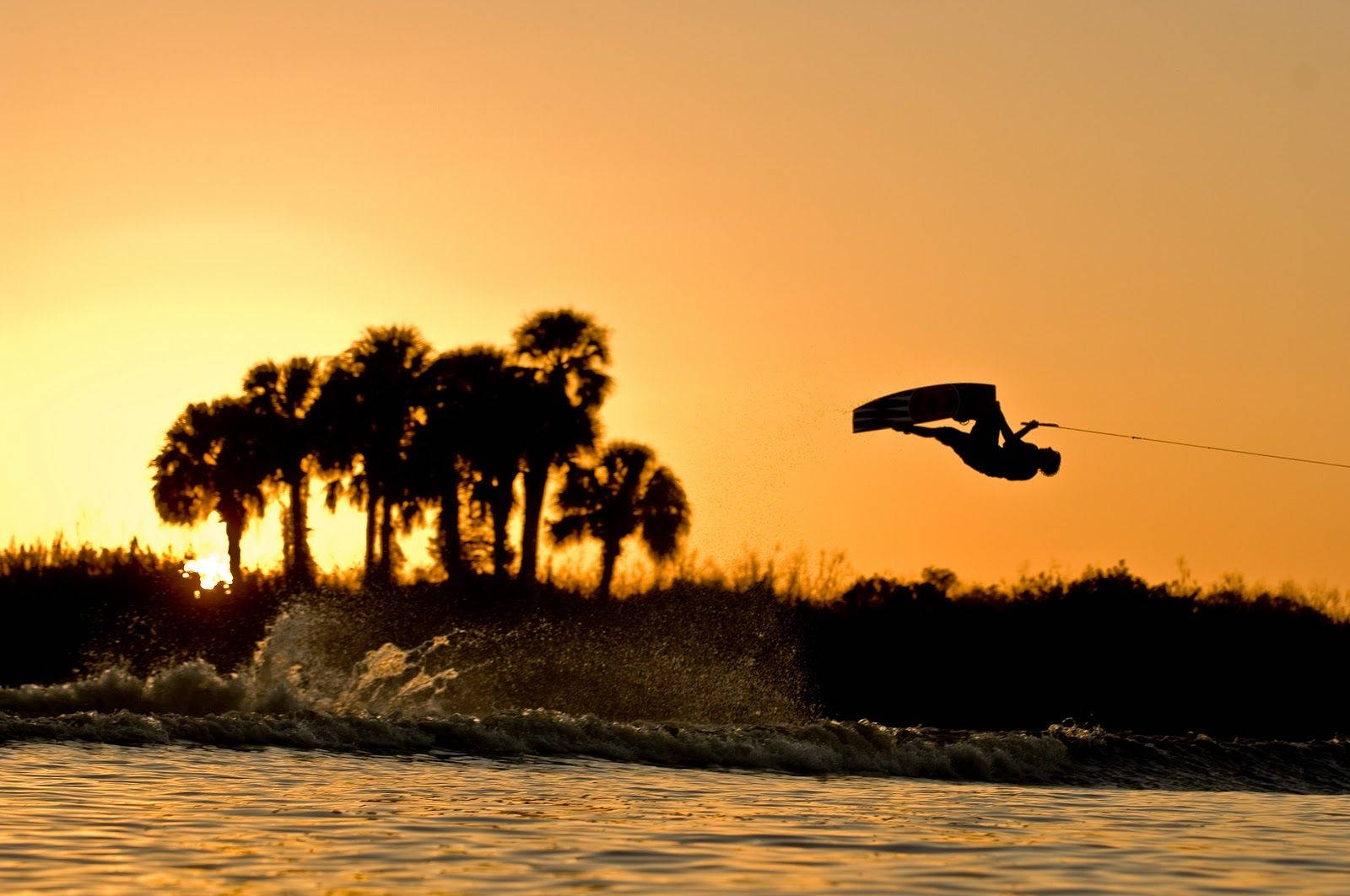 Caption: Impressive Aerial Wakeboarding Stunt Wallpaper