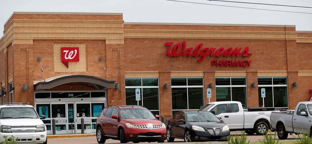 A Walgreens Pharmacy With Cars Parked Outside