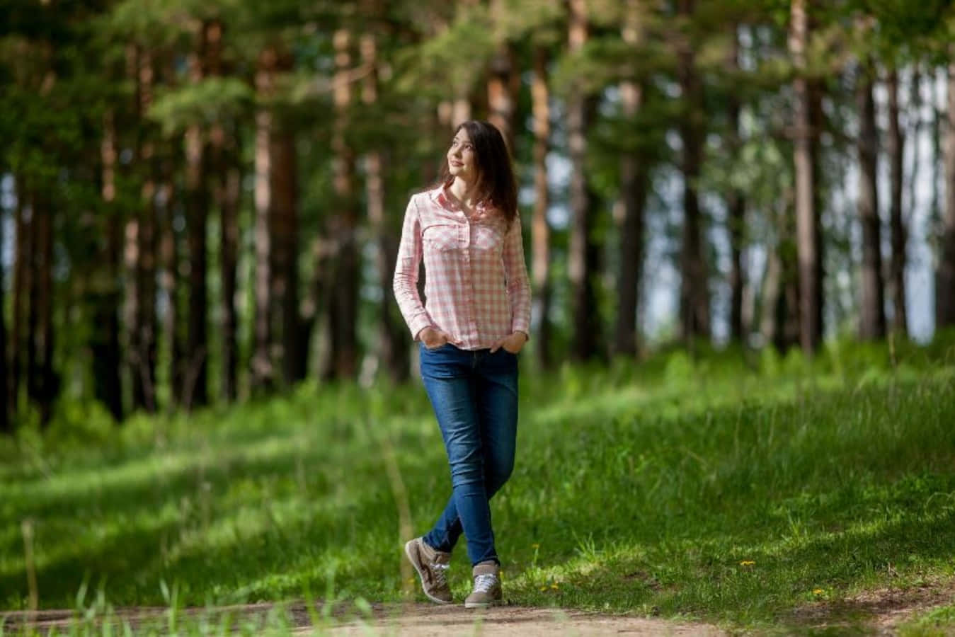 A Young Woman Walking In The Forest