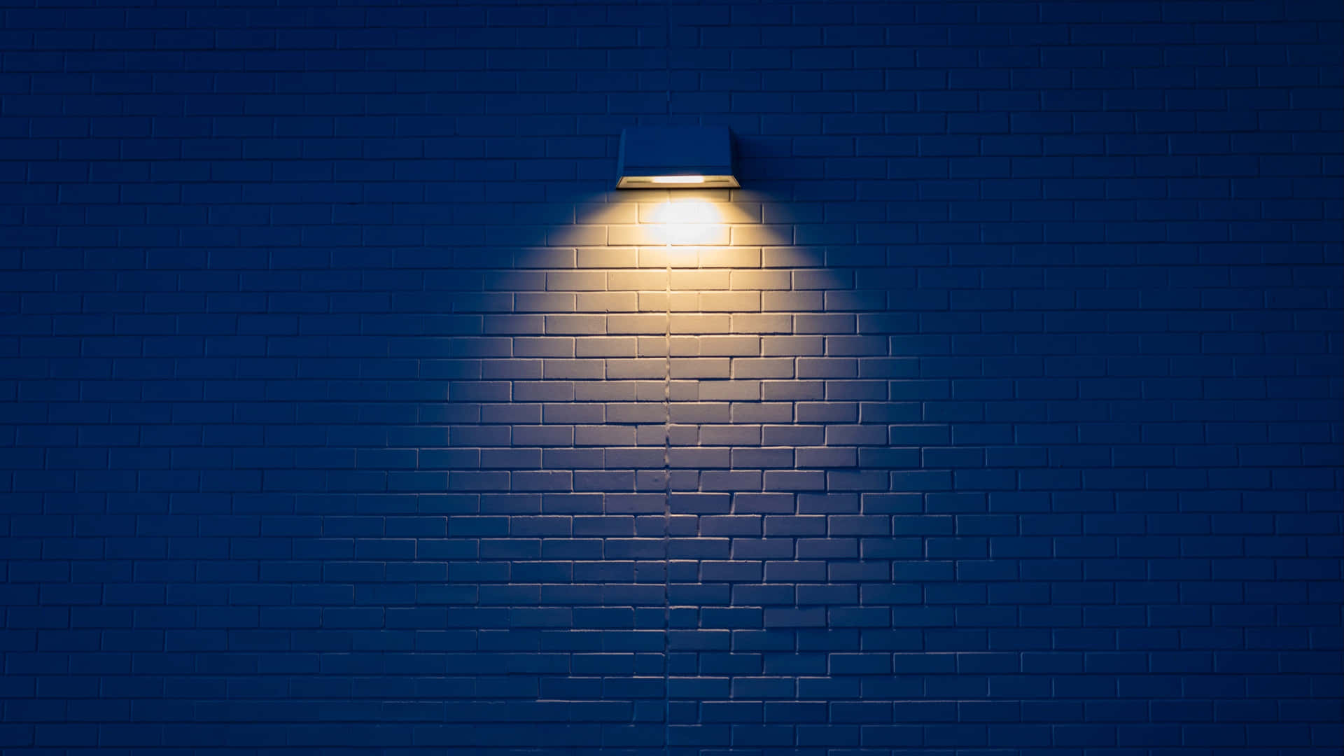 Wall Mounted Lamp Illuminating Bricks Wallpaper