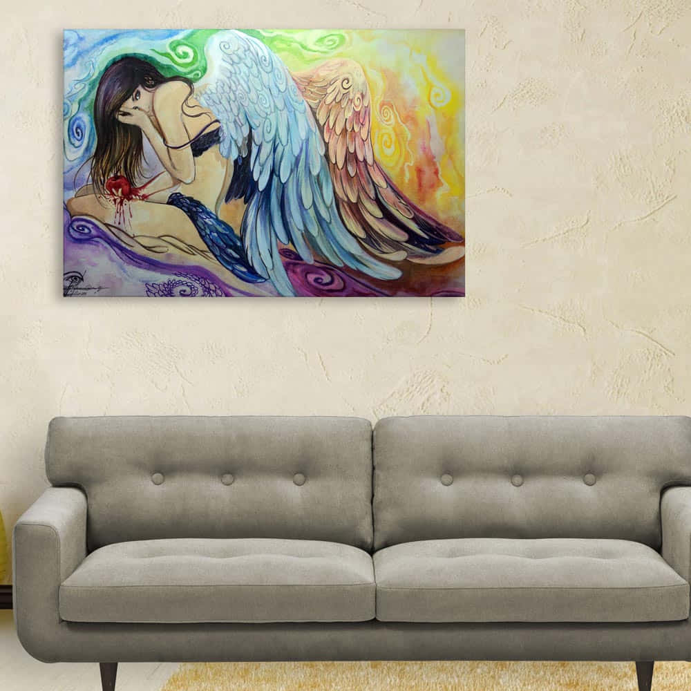 A Painting Of An Angel With Wings Hanging Above A Couch