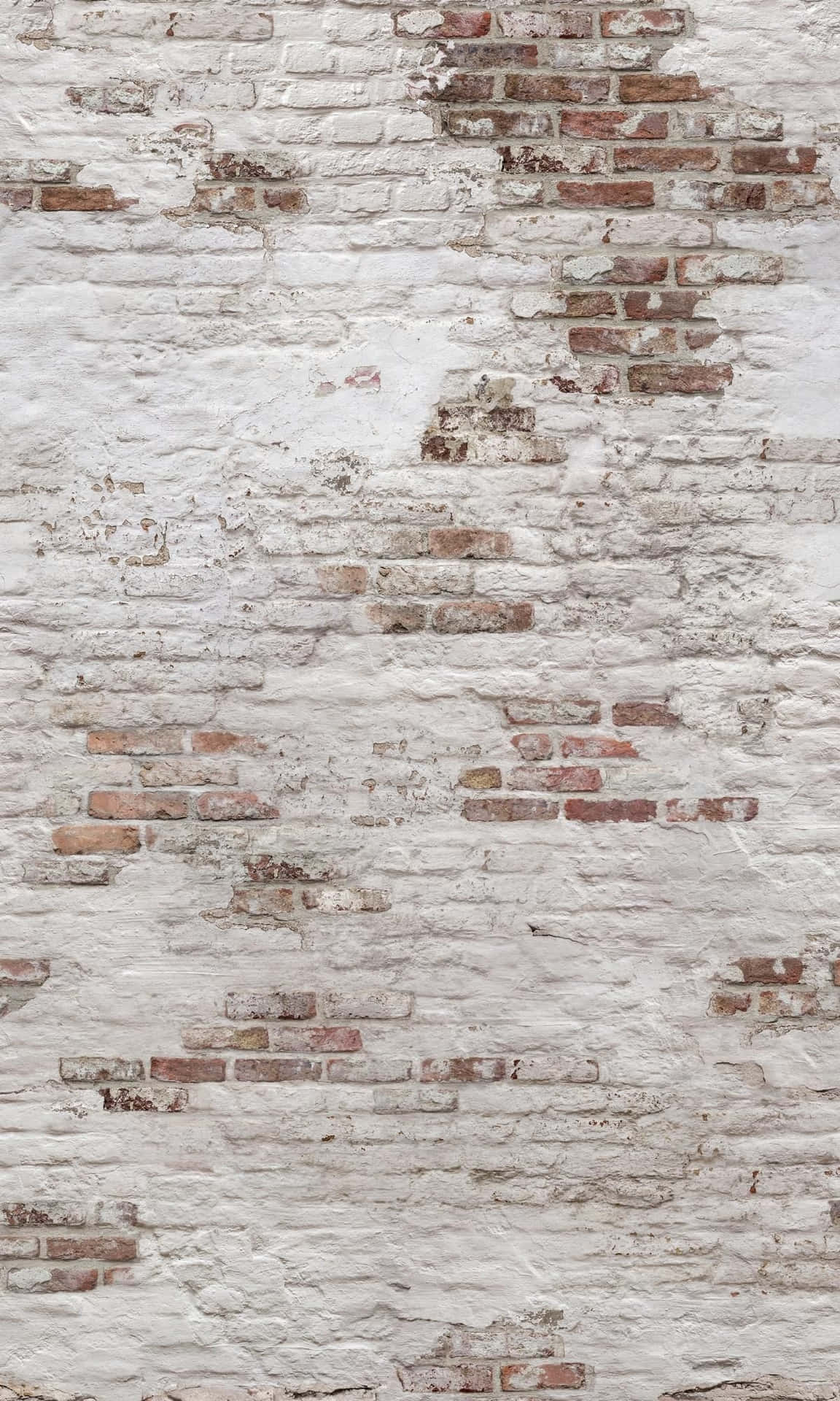 A White Brick Wall With White Paint On It