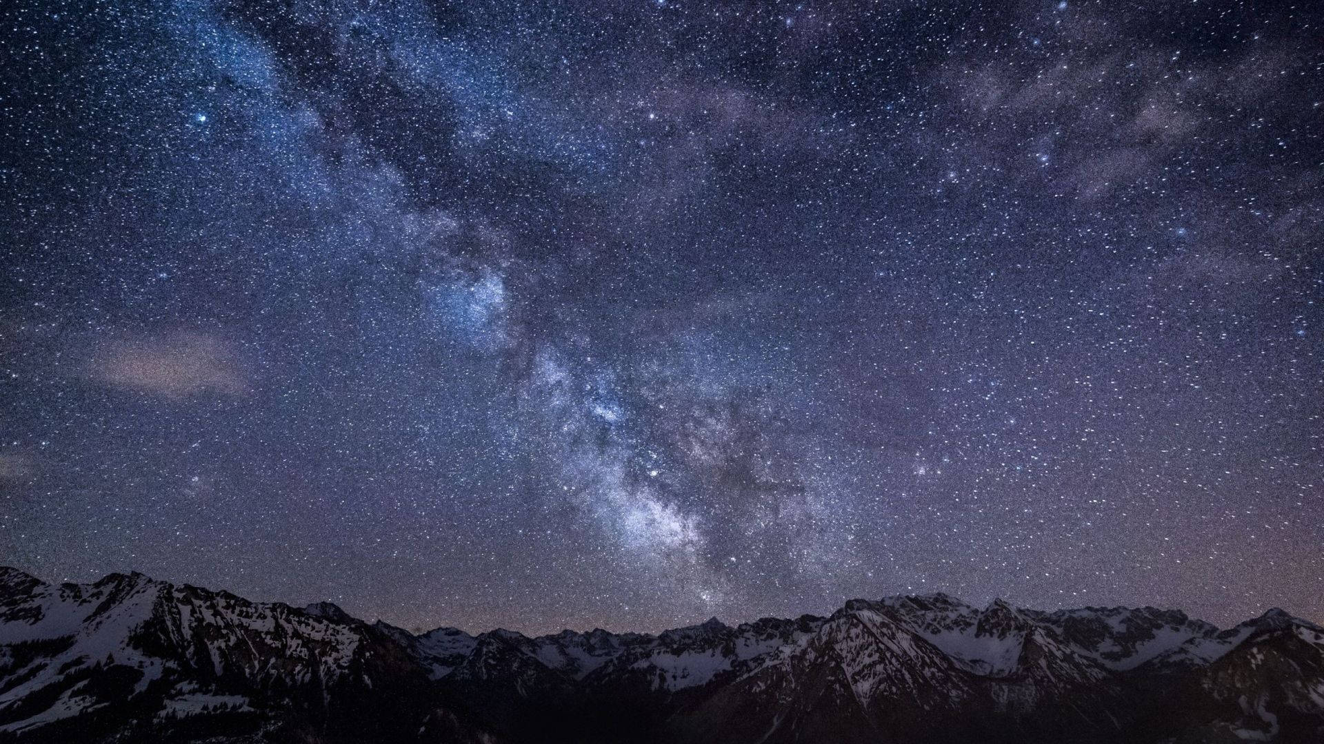 Stargazing in the Captivating Night Sky Wallpaper
