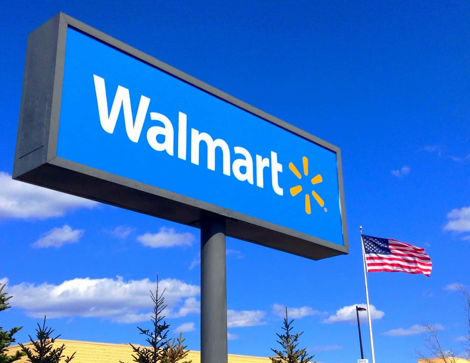 walmart sign in front of a blue sky