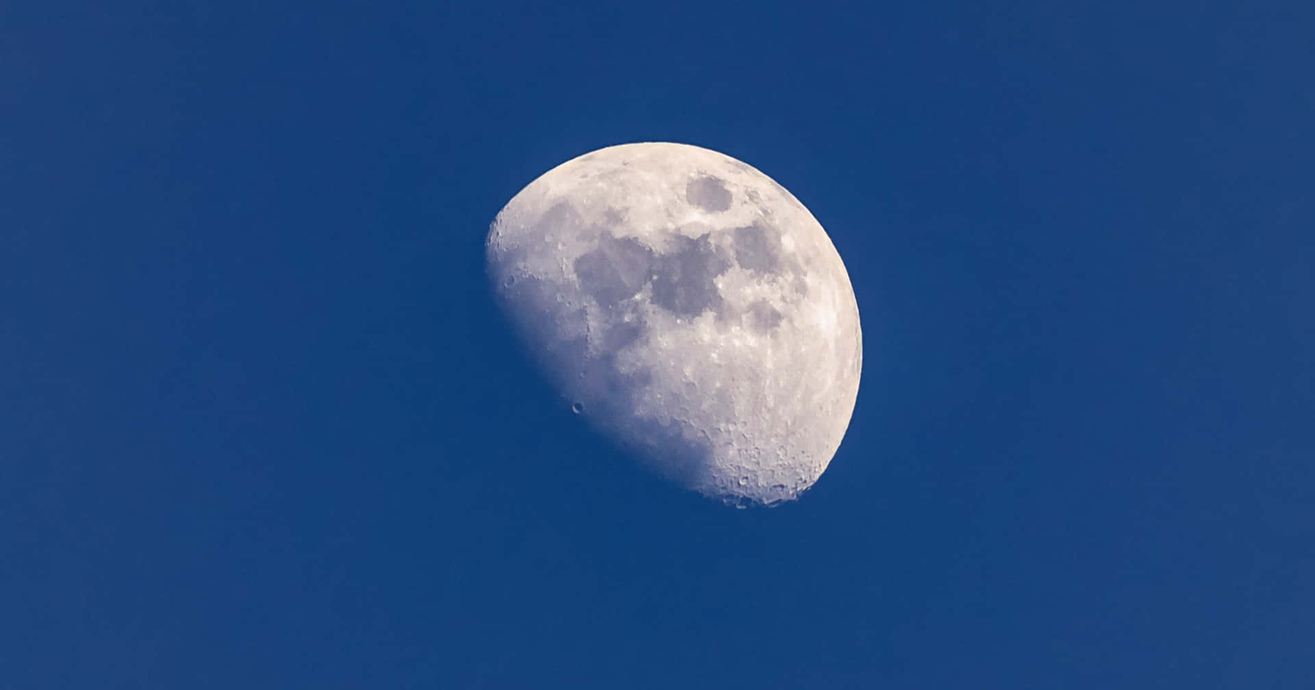 Waning Gibbous Moon Against Blue Sky Wallpaper