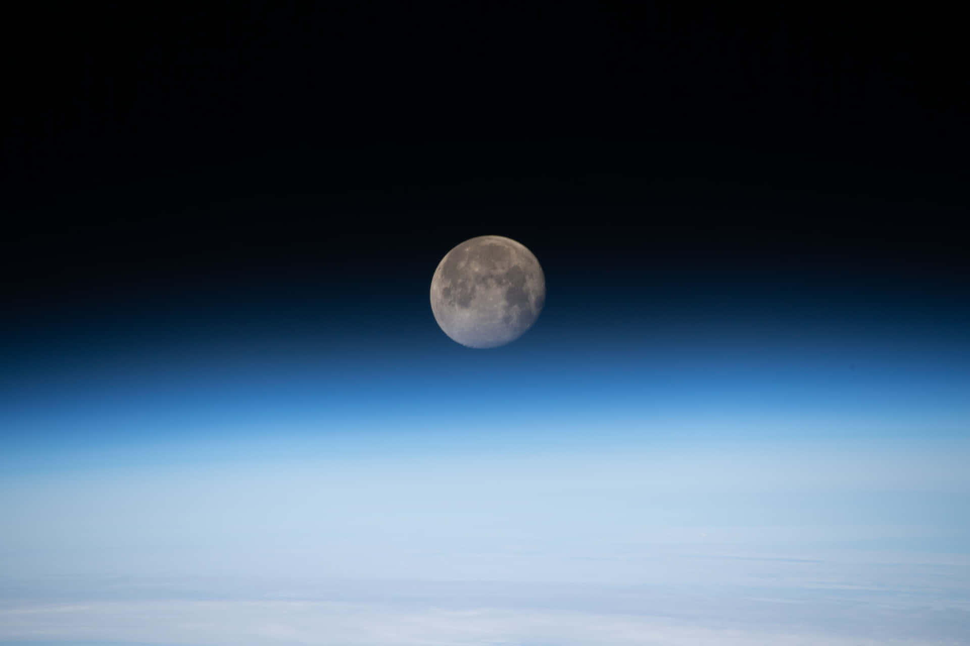 Waning Gibbous Moon Over Earth Horizon Wallpaper