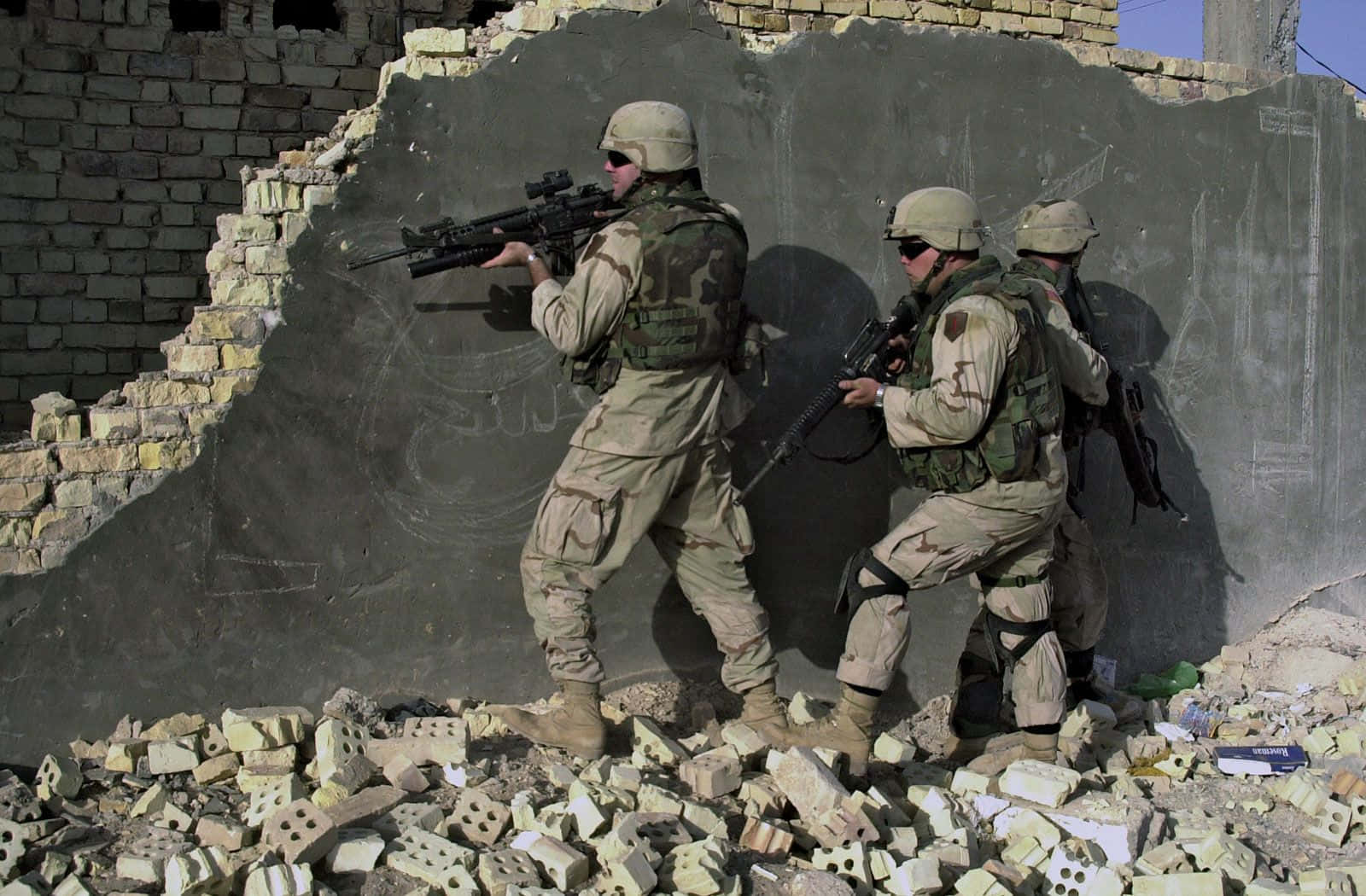 Soldiers Standing In Front Of A Building With A Rifle