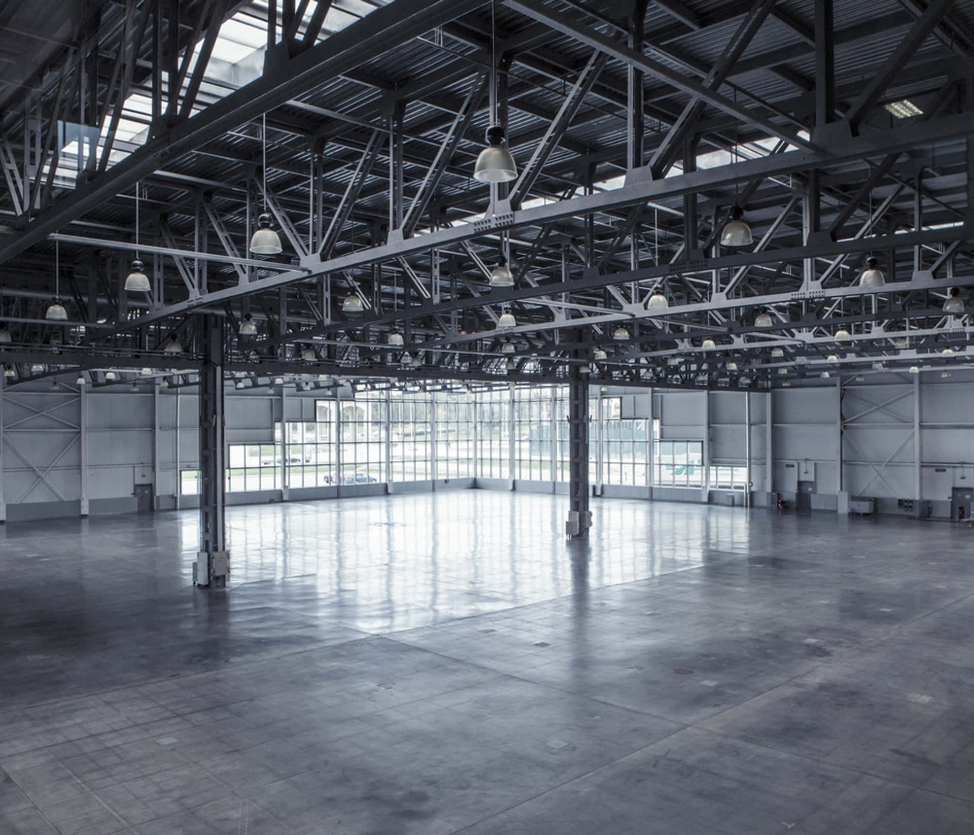 Empty Warehouse With Steel Beams And Concrete Floor