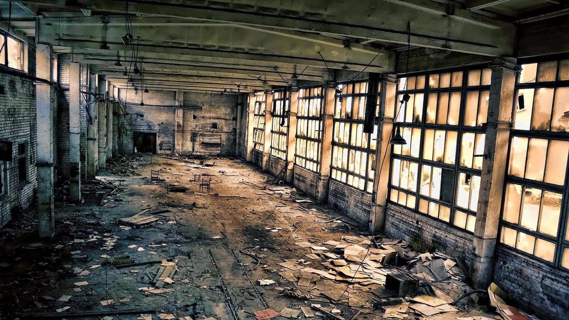 An Abandoned Factory With Broken Windows And A Broken Floor