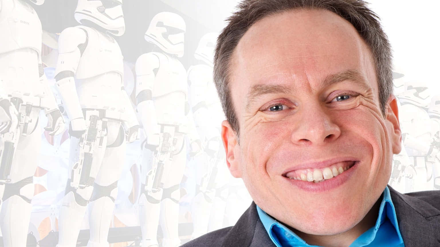 Warwick Davis posing with confidence at a public event Wallpaper