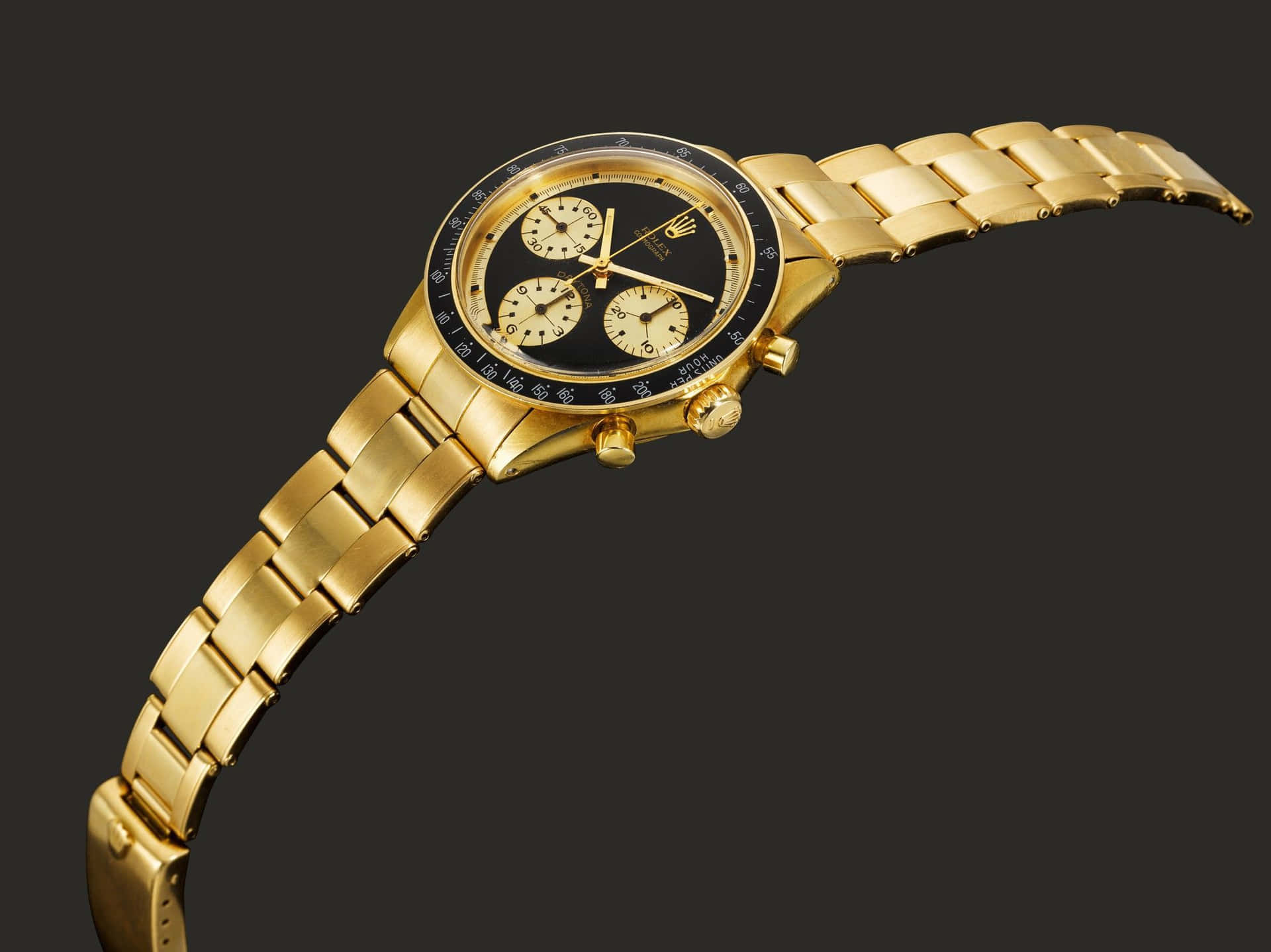 A Gold Watch With Black Dials On A Black Background
