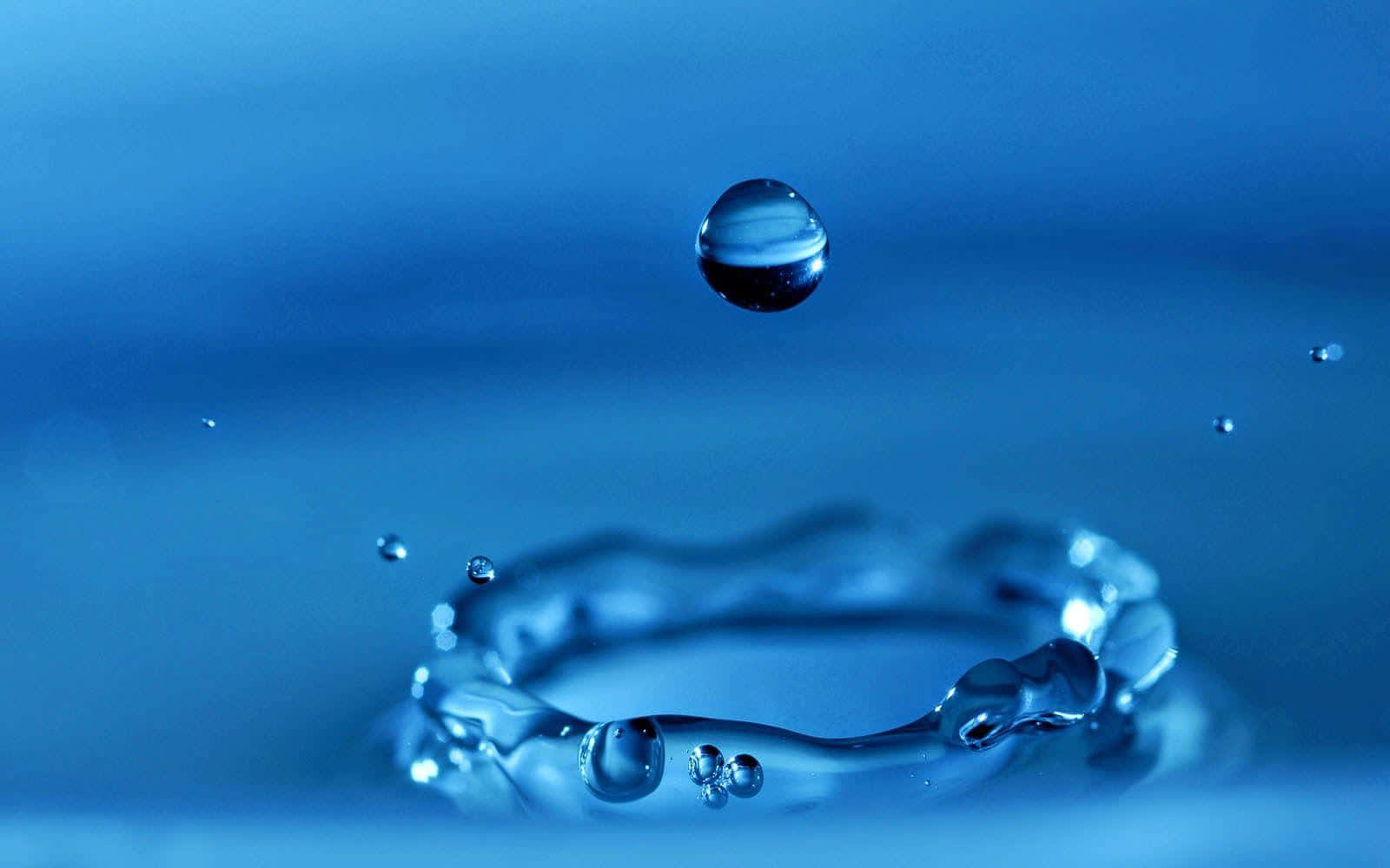 Water Droplet In Blue Water