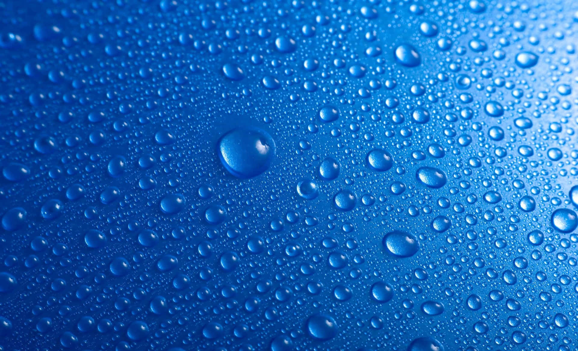 Blue Water Droplets On A Blue Surface